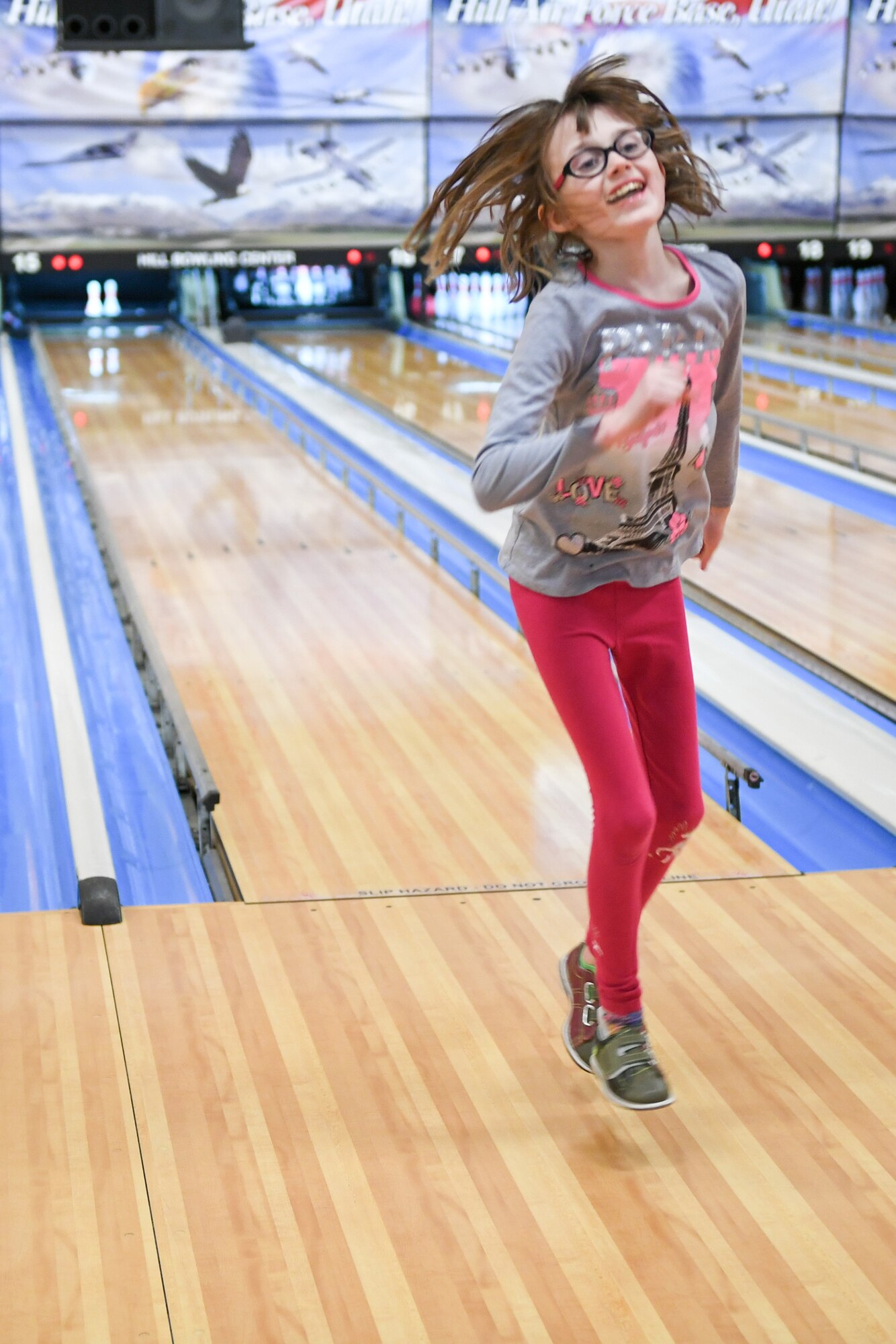 Hailey Cook jumps while bowling Jan. 30, 2019, at the event held by Exceptional Family Member Program-Family Support at Hill Air Force Base, Utah. (U.S. Air Force photo by Cynthia Griggs)