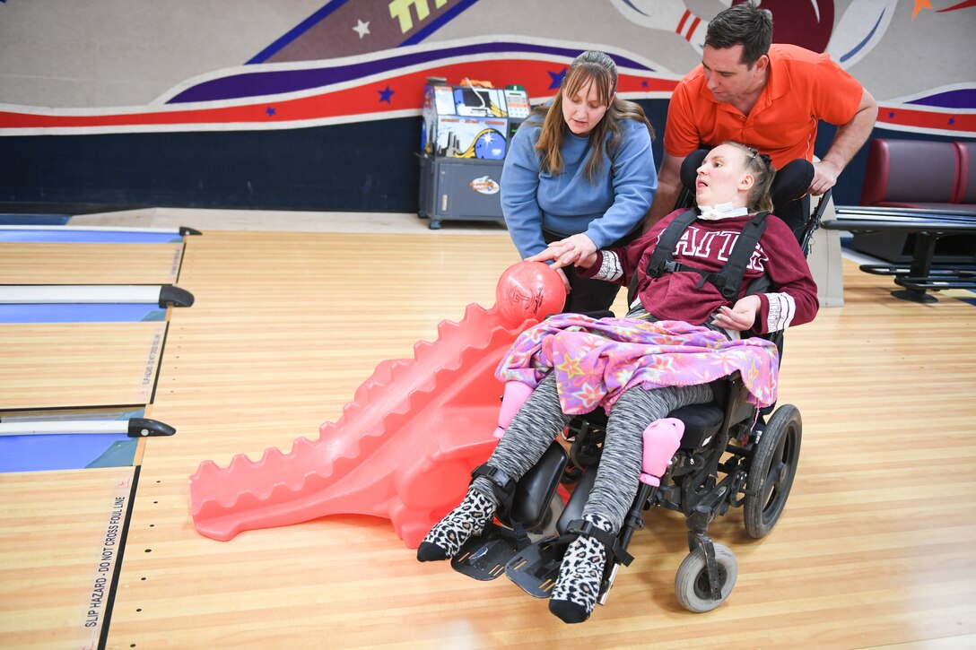 Master Sgt. John Bartlow and wife Jennifer help their daughter Ellie Prewitt bowl Jan. 30, 2019, at the bowling event held by Exceptional Family Member Program-Family Support at Hill Air Force Base, Utah. (U.S. Air Force photo by Cynthia Griggs)