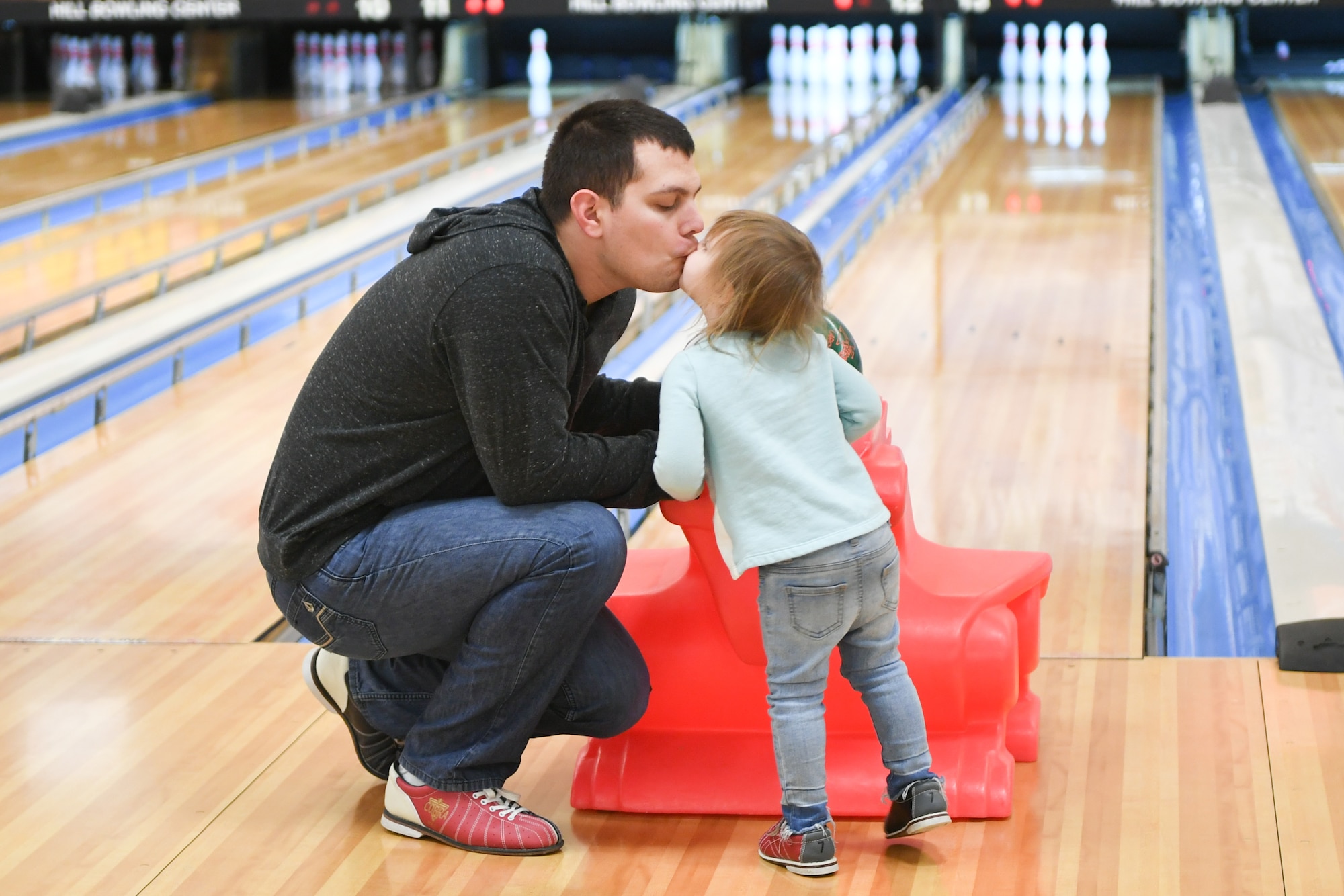 Airman Matthew Carvajal shares a moment with his daughter Ella before she bowls Jan. 30, 2019, at the bowling event held by Exceptional Family Member Program-Family Support at Hill Air Force Base, Utah. (U.S. Air Force photo by Cynthia Griggs)