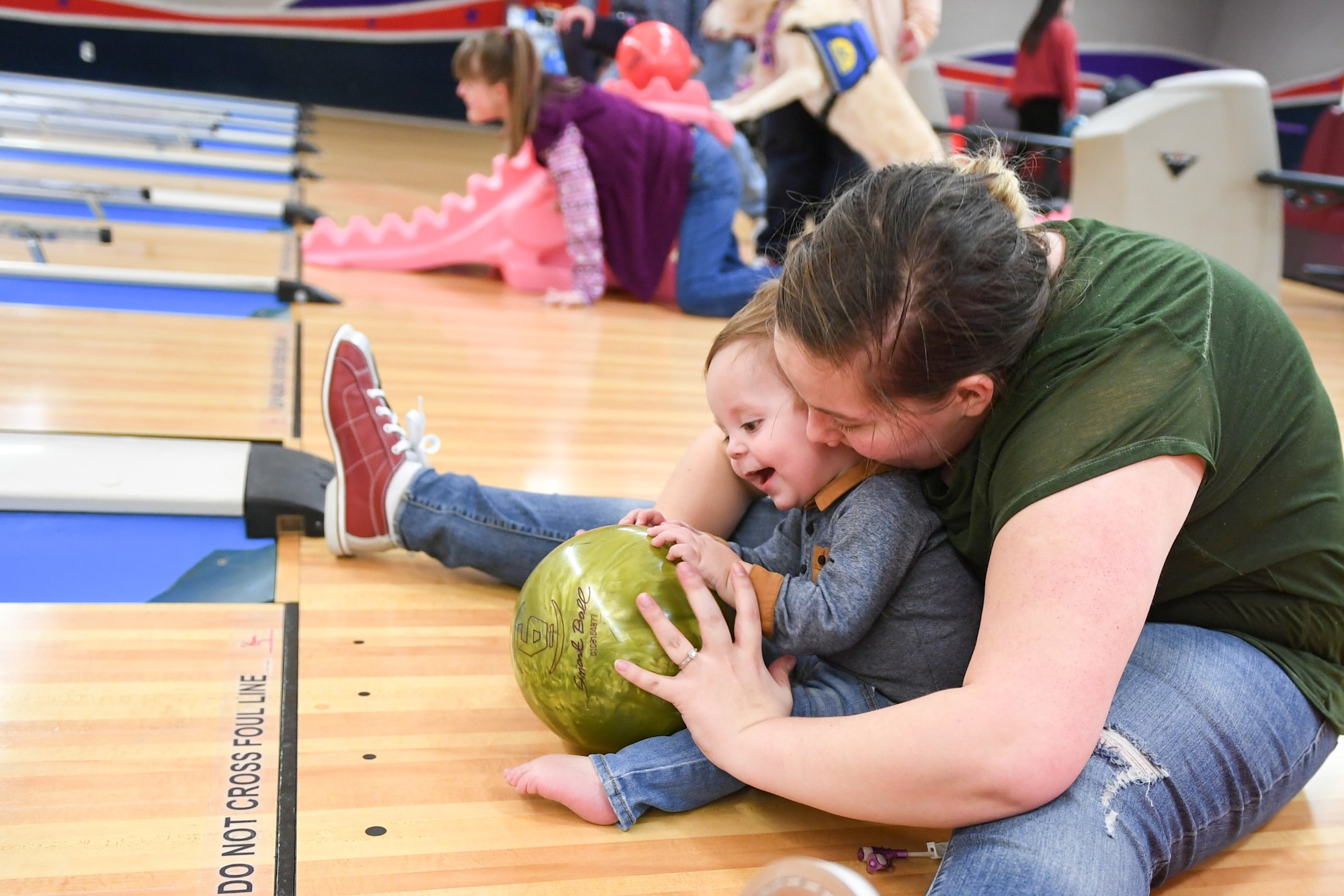 Alyssa Carvajal bowls with her son, Easton, Jan. 30, 2019, at the bowling event held by Exceptional Family Member Program-Family Support at Hill Air Force Base, Utah. (U.S. Air Force photo by Cynthia Griggs)