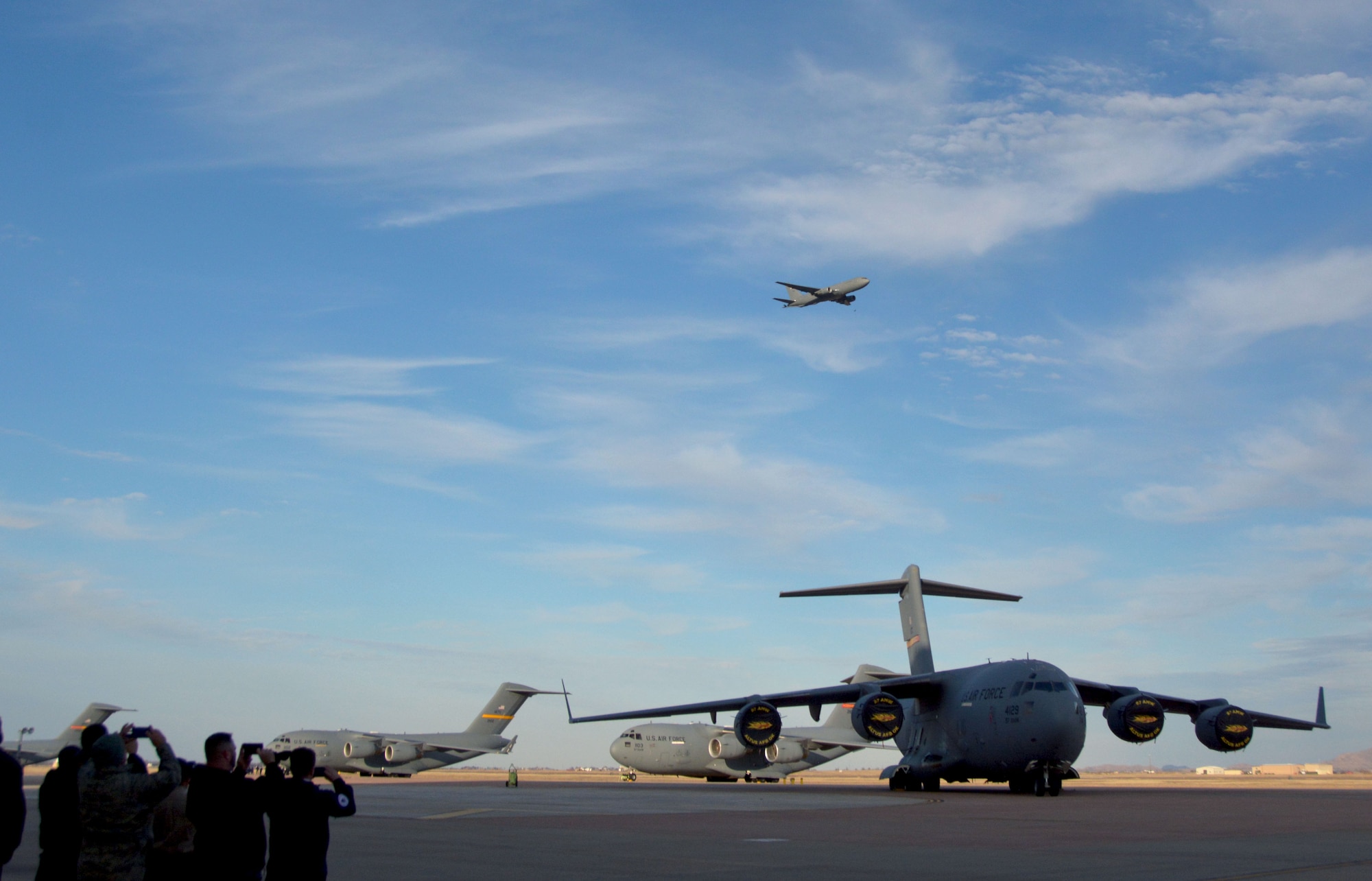 Onlookers snap photos as a KC-46A Pegasus flies overhead at Altus Air Force Base, Oklahoma, Feb. 8, 2019. Reserve Citizen Airmen of the 730th Air Mobility Training Squadron, dignitaries and Air Force leaders accepted the new KC‐46A Pegasus during a historic arrival celebration. (U.S. Air Force photo by Tech. Sgt. Samantha Mathison)