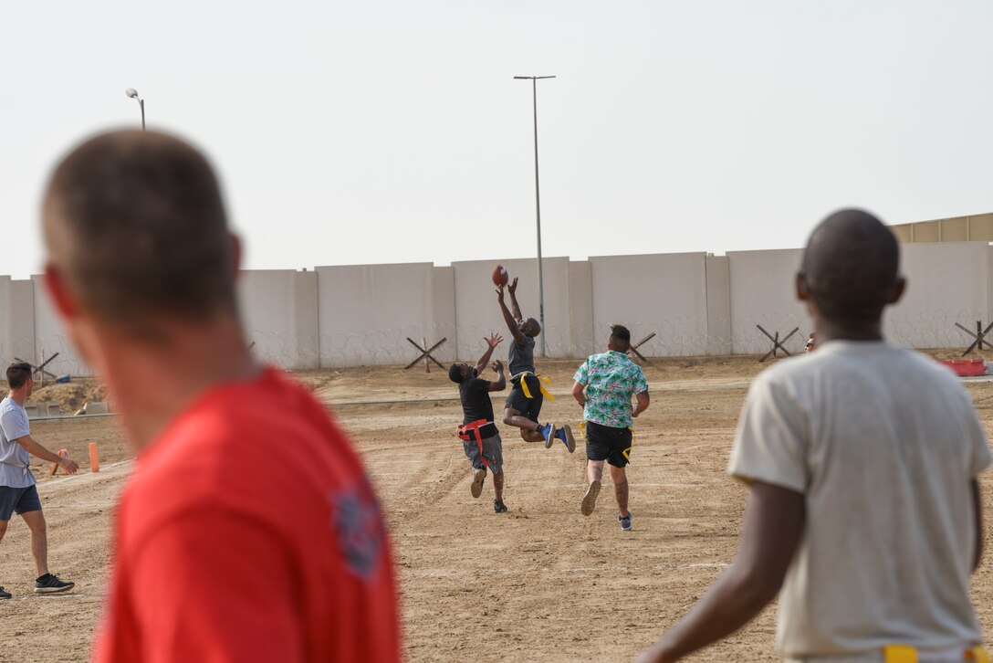 Members assigned to Al Dhafra Air Base, United Arab Emirates, participate in an intramural football tournament game, Nov. 11, 2018. The 380th Expeditionary Force Support Squadron Fitness Center Staff hosts intramural sporting including softball, football and basketball, for ADAB personnel to remain fit to fight while having fun. (U.S. Air Force photo by Tech. Sgt. Darnell T. Cannady)