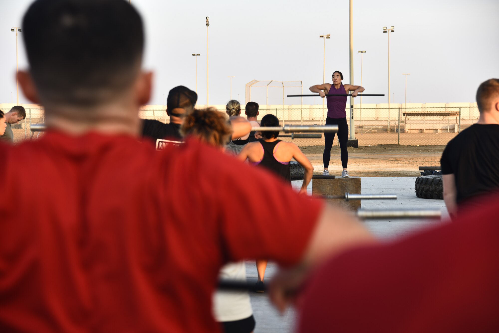 Stephanie Chung, professional CrossFit athlete, demonstrates basic CrossFit techniques during a meet-and-greet event at Al Dhafra Air Base, United Arab Emirates, Dec. 21, 2018. The 380th Expeditionary Force Support Squadron Fitness Center Staff coordinates meet-and-greets with professional athletes. (U.S. Air Force photo by Senior Airman Mya M. Crosby)
