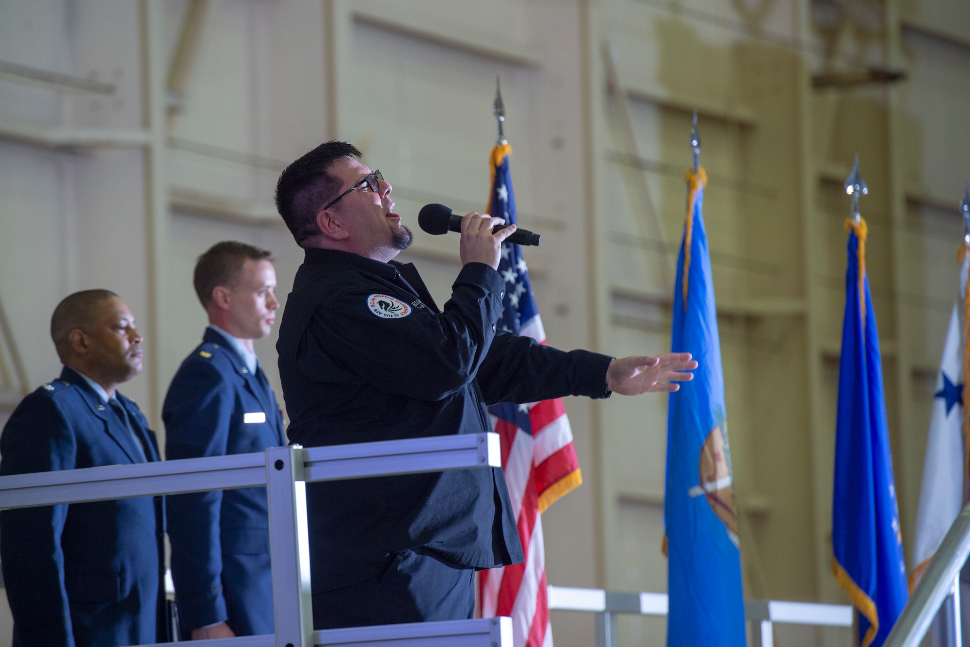 Blake Pewo, a KC-46A Pegasus mechanic from the 97th Maintenance Group, sings the national anthem during a welcoming ceremony for the delivery of the KC-46, Feb. 8, 2019, at Altus Air Force Base, Okla.  Global air refueling is the foundation of global mobility and the bedrock of the nation’s ability to deploy forces. (U.S. Air Force Photo by Senior Airman Jackson N. Haddon)