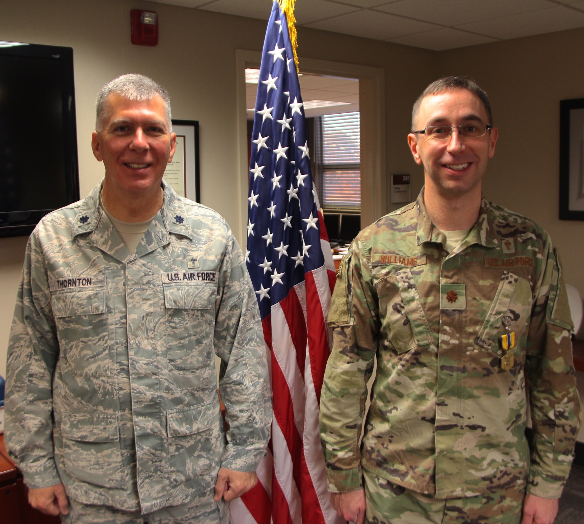 At left, Chaplain (Lt. Col.) Thornton shares a smile as he presents the Air Force Commendation Medal to Chaplain (Maj.) Michael Williams, for Meritorious Service in a special ceremony held Feb. 9, 2019, at Scott Air Force Base, Illinois.  The medal and certificate recognized Chaplain Williams work over a long multi-year period starting in September 2012.  The 932nd AW Chapel Corps of chaplains and chaplain assistants, referred to as Religious Support Teams (RST), have the privilege of focusing on caring for unit members and their families throughout the deployment cycle and beyond. Unit visits and personal engagements are a part of this warrior care. "The 932nd AW team provide proactive pastoral care as well as religious accommodations that meet diverse spiritual needs, in order to foster the spiritual pillar of Comprehensive Airman Fitness within the Wing," said Chaplain Thornton, who also retires today.