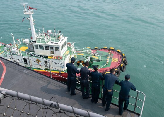 U.S. Sailors observe a tug boat as the aircraft carrier USS John C. Stennis (CVN 74) pulls in to Laem Chabang, Thailand, Feb. 10, 2019. The John C. Stennis is deployed to the U.S. 7th Fleet area of operations in support of security and stability in the Indo-Pacific region.