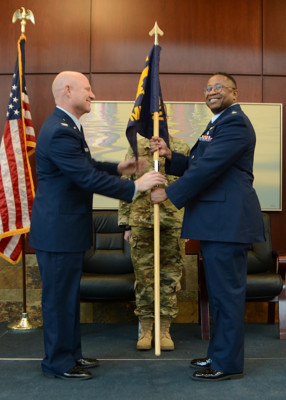 Lt. Col. (Dr.) Alvin Bradford accepts the guideon from the 507th Air Refueling Wing Commander, Col. Miles Heaslip, during the 507th Medical Squadron assumption of command ceremony at Tinker Air Force Base, Oklahoma, Feb. 9, 2019. Prior to assuming command, Bradford served as the Chief of Aerospace Medicine in the 507th MDS. (U.S. Air Force photo by Master Sgt. Grady Epperly)
