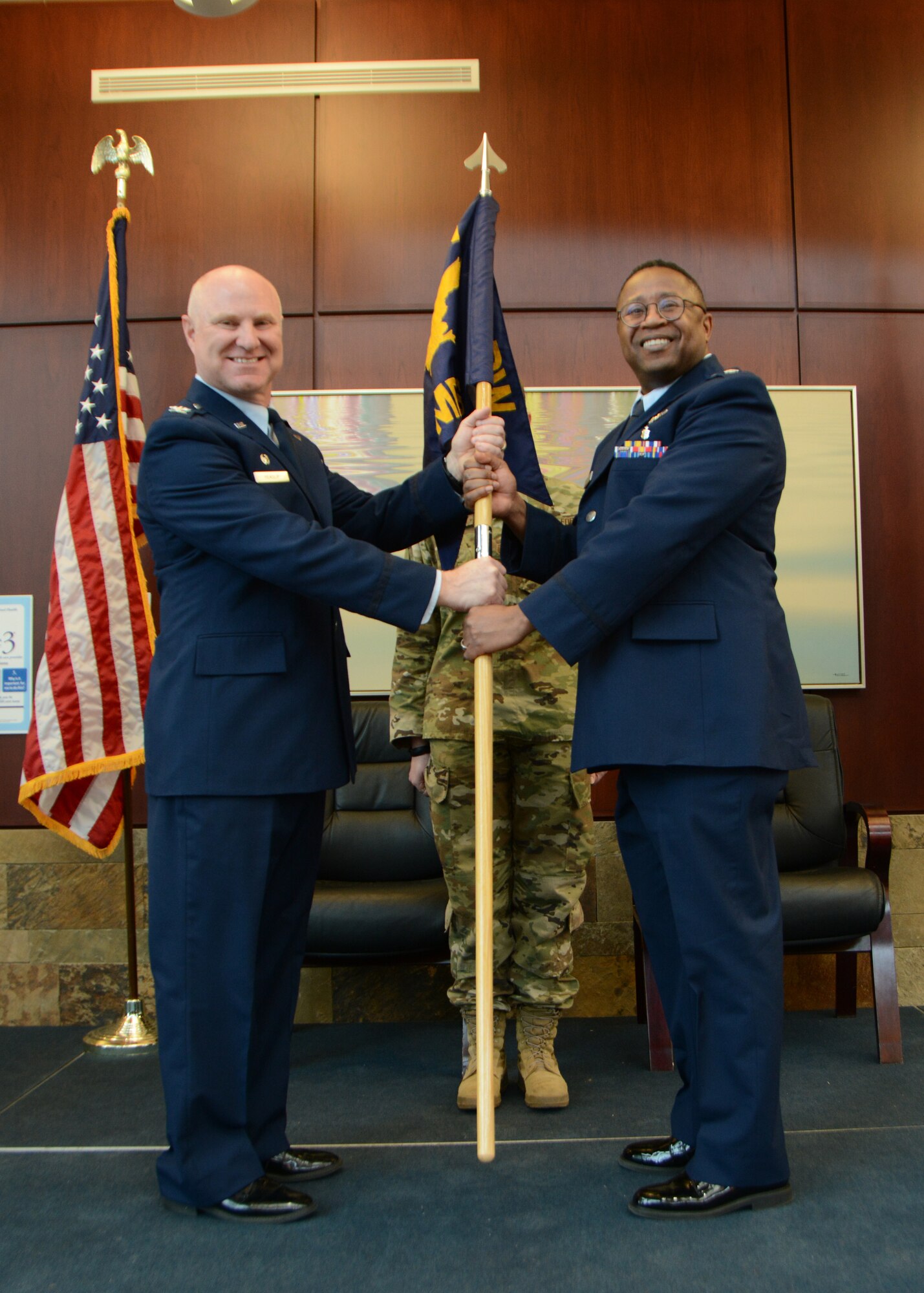Lt. Col. (Dr.) Alvin Bradford accepts the guideon from the 507th Air Refueling Wing Commander, Col. Miles Heaslip, during the 507th Medical Squadron assumption of command ceremony at Tinker Air Force Base, Oklahoma, Feb. 9, 2019. Prior to assuming command, Bradford served as the Chief of Aerospace Medicine in the 507th MDS. (U.S. Air Force photo by Master Sgt. Grady Epperly)
