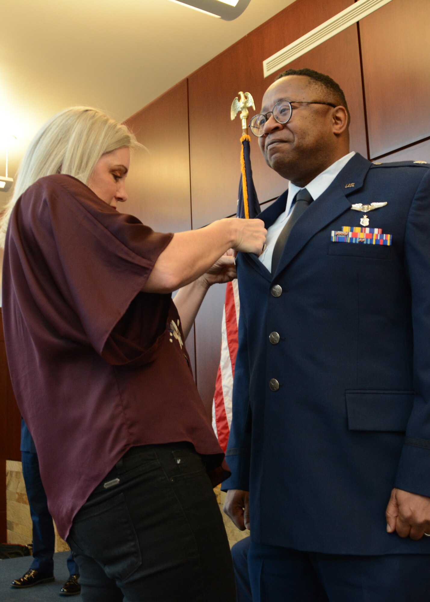 Lt. Col. (Dr.) Alvin Bradford's wife, Dina, attaches the commanders pin onto Bradford's service coat for the first time during the 507th Medical Squadron assumption of command ceremony at Tinker Air Force Base, Oklahoma, Feb. 9, 2019. Prior to assuming command, Bradford served as the Chief of Aerospace Medicine in the 507th MDS. (U.S. Air Force photo by Master Sgt. Grady Epperly)