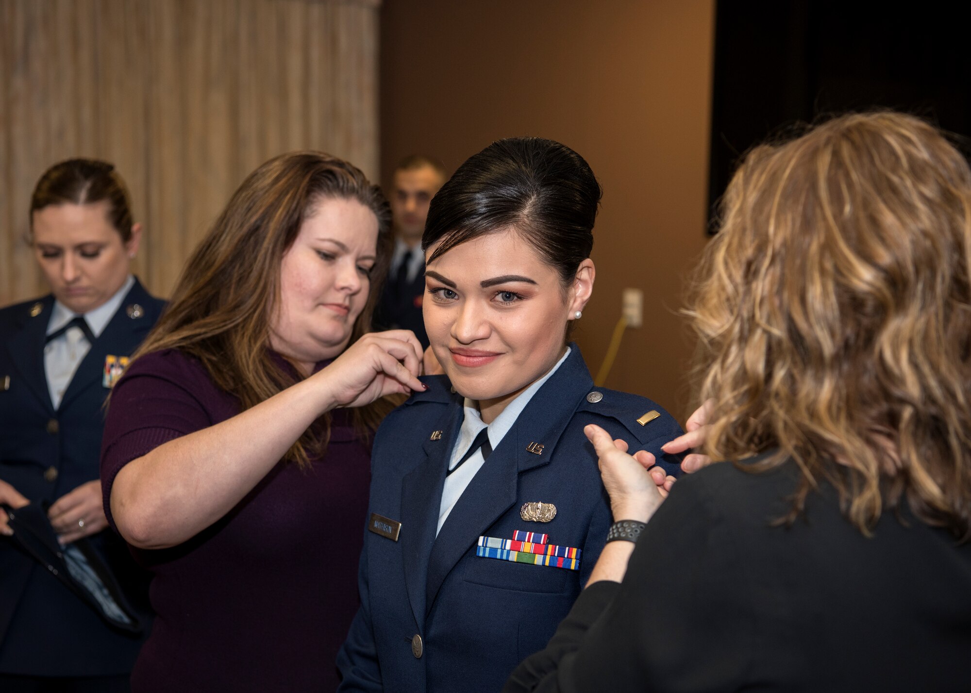 (From left) Technical Sgt. Tanya Sweeney, 104th Force Support Squadron dining facility NCO in charge, Lisa Potito 104th Fighter Wing Airman and Family Readiness program manager, 2nd Lt. Nicolle Mathison, and Senior Master Sgt. Sandra Woodin, 104 FSS base services superintendent, participate in Mathison's commissioning ceremony, Feb. 7, 2018, at Barnes Air National Guard Base. Mathison chose the three women to pin on her rank of second lieutenant during the ceremony because of the impact they've had on her. (U.S. Air National Guard photo by Airman 1st Class Randy Burlingame)