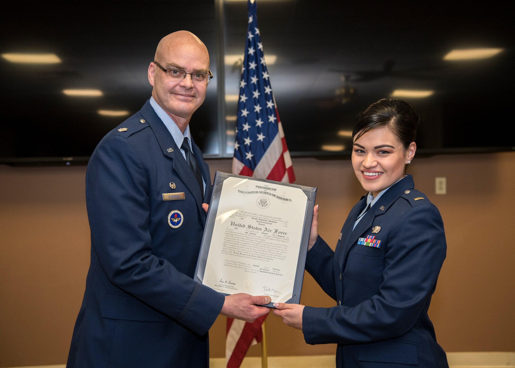 Lieutenant Colonel Mark Guerber, detachment commander for University of Massachusetts in Amherst Reserve Officer Training Corps Detachment 370, and 2nd Lt. Nicolle Mathison pose for a photo Feb. 7, 2018, at Barnes Air National Guard Base. Mathison will serve as a public affairs officer at Nellis Air Force Base. (U.S. Air National Guard photo by Airman 1st Class Randy Burlingame)
