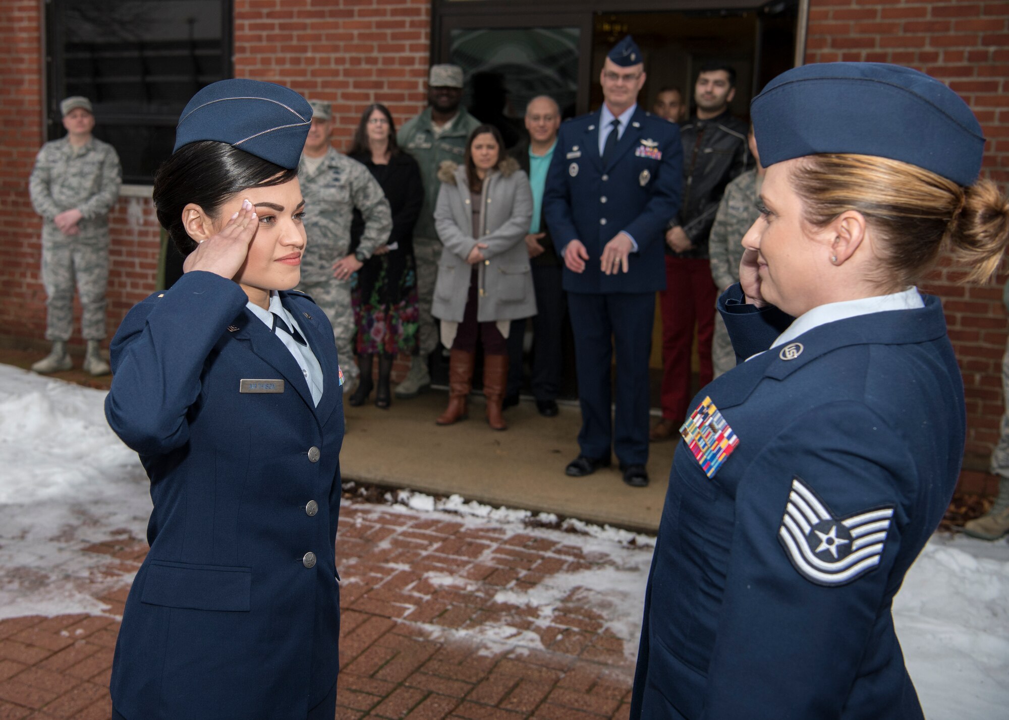 Second Lieutenant Nicolle Mathison salutes Tech. Sgt. Tanya Sweeney, 104th Force Support Squadron dining facility NCO in charge, Feb. 7, 2018, at Barnes Air National Guard Base. The first salute is a time honored tradition where a newly commissioned officer salutes somebody that has had an impact on them. (U.S. Air National Guard photo by Airman 1st Class Randy Burlingame)