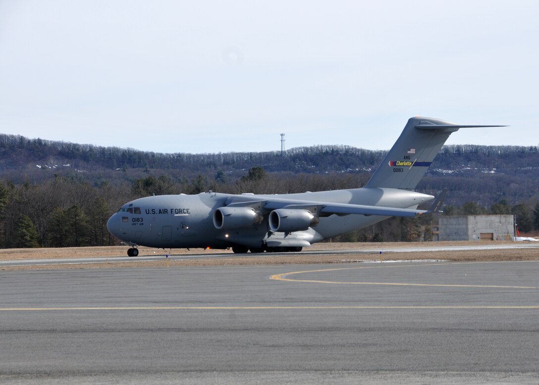A C-17 Globemaster III from the 145th Airlift Wing  in Charlotte, North Carolina supports the 104th Fighter Wing Feb. 10, 2019, at Barnes Air national Guard Base, Massachusetts. the C-17 brought Airmen and equipment from Patrick Air Force Base, Florida back to the 104th Fighter Wing after a two week temporary dury assignment where the Airmen recieved training essential to the success of the mission.   (U.S. Air National Guard Photos by Tech. Sgt. Lindsey Sarah Watson-Kirwin)
