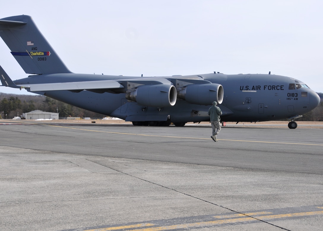 A C-17 Globemaster III from the 145th Airlift Wing  in Charlotte, North Carolina supports the 104th Fighter Wing Feb. 10, 2019, at Barnes Air national Guard Base, Massachusetts. the C-17 brought Airmen and equipment from Patrick Air Force Base, Florida back to the 104th Fighter Wing after a two week temporary dury assignment where the Airmen recieved training essential to the success of the mission.   (U.S. Air National Guard Photos by Tech. Sgt. Lindsey Sarah Watson-Kirwin)