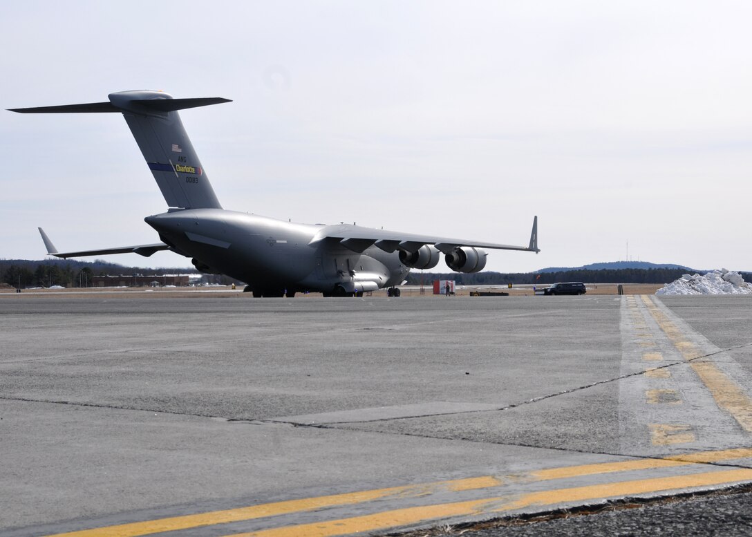 A C-17 Globemaster III from the 145th Airlift Wing  in Charlotte, North Carolina supports the 104th Fighter Wing Feb. 10, 2019, at Barnes Air national Guard Base, Massachusetts. the C-17 brought Airmen and equipment from Patrick Air Force Base, Florida back to the 104th Fighter Wing after a two week temporary dury assignment where the Airmen recieved training essential to the success of the mission.   (U.S. Air National Guard Photos by Tech. Sgt. Lindsey Sarah Watson-Kirwin)