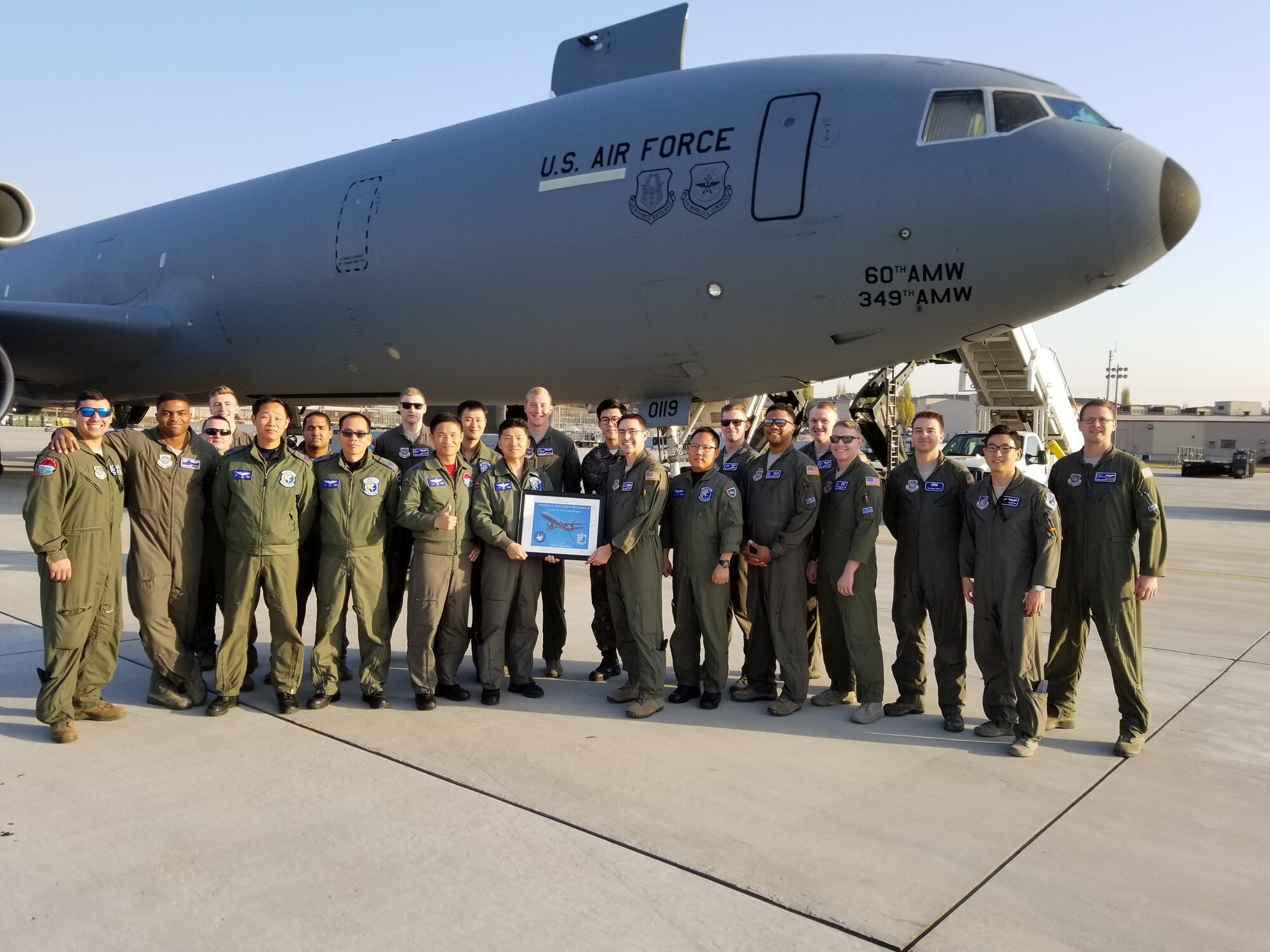 U.S. Airmen assigned to the 6th Air Refueling Squadron from Travis Air Force Base, California, and Republic of Korea airmen with the 261st Air Refueling Squadron pose for a photo together in front of a KC-10 Extender at Osan Air Base, ROK, Nov. 11, 2018. (Courtesy photo by Captain Jason Lim)