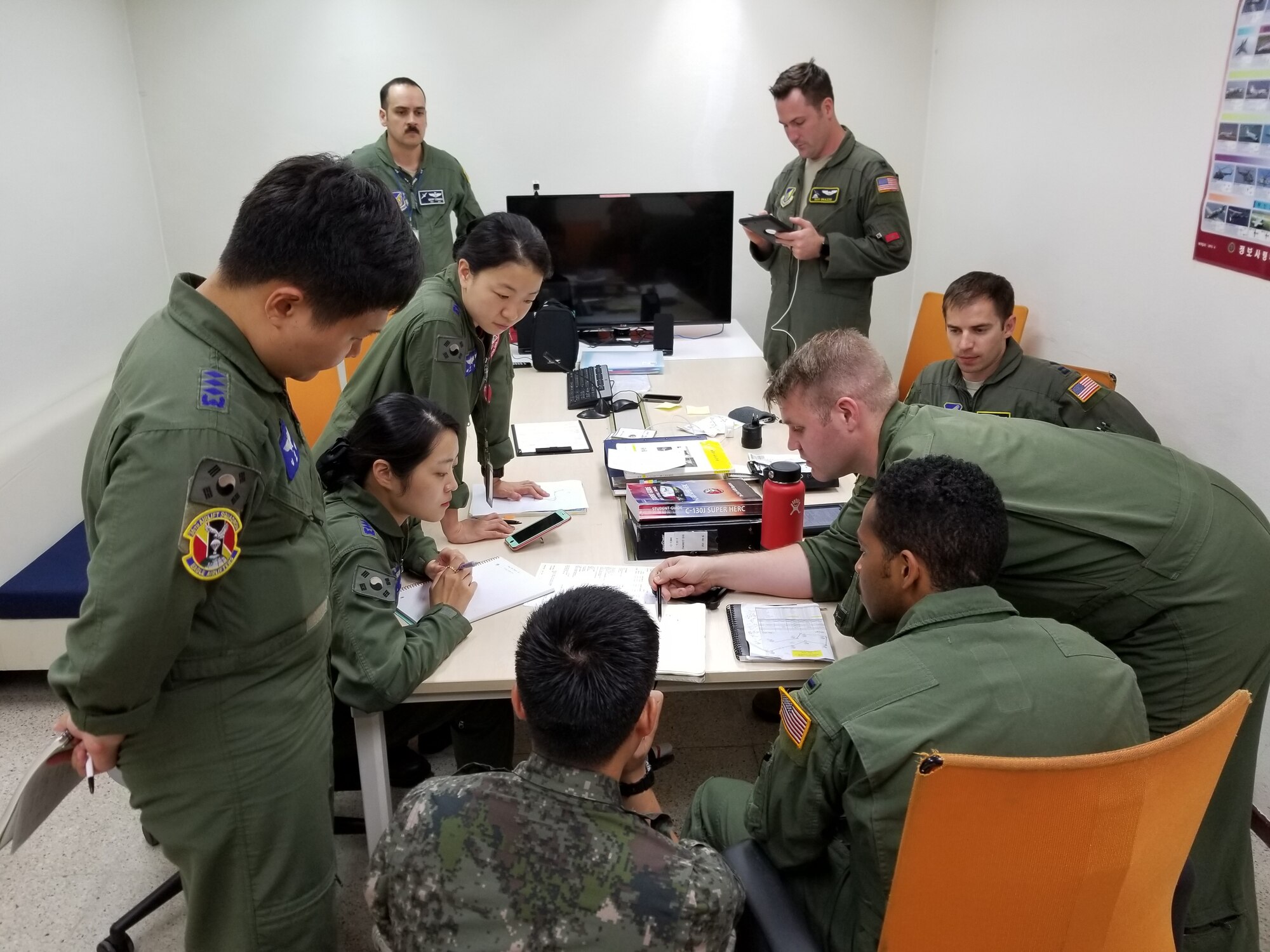 U.S. Airmen assigned to the 36th Tactical Airlift Squadron from Yokota Air Base, Japan, and Republic of Korea airmen assigned to the 251st Airlift Squadron conduct mission planning at Gimhae Air Base, July 2018. (Courtesy photo by Captain Jason Lim)