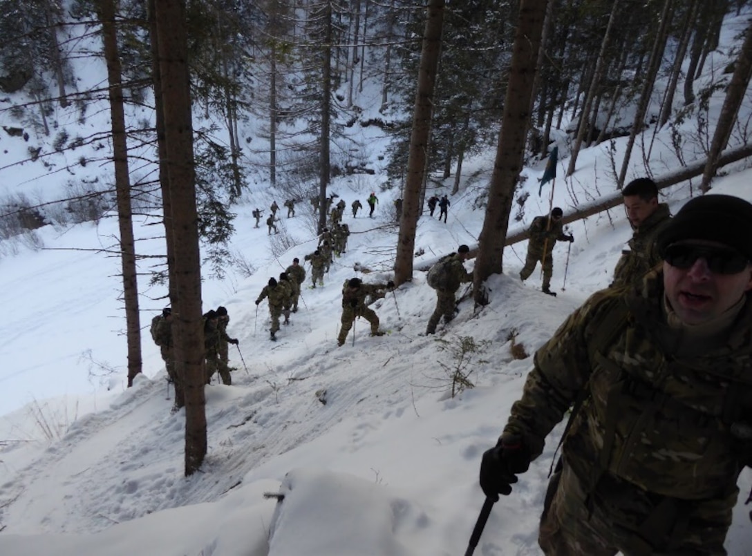 Members of the 2500th Digital Liason Detachment climb Refugio peak near Wiessenbach, Italy, Jan. 12 during the unit's three-day battle assembly, Jan 11-13. The unit climbed to the peak with the 6th Alpini Regiment of the Italian army.