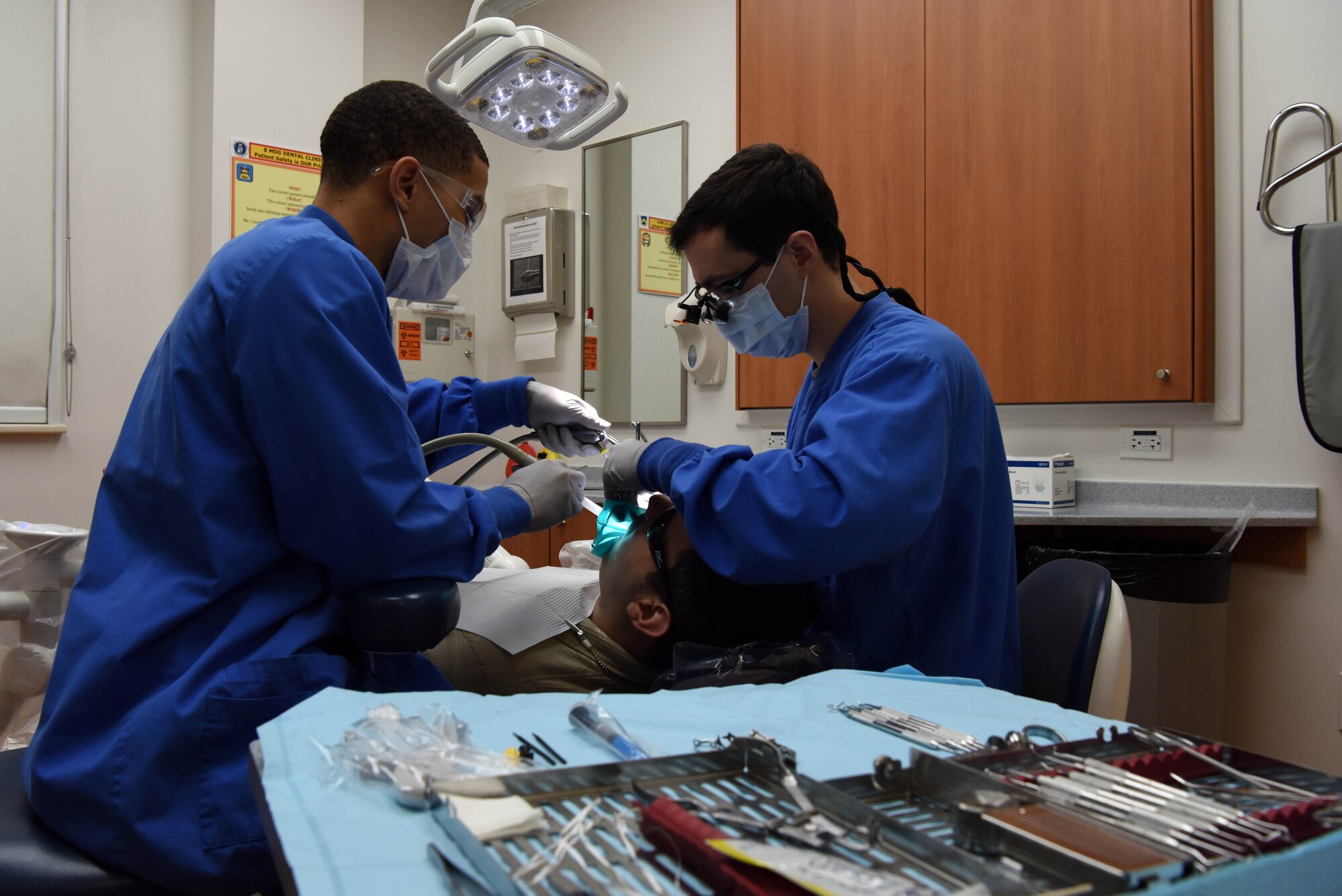 U.S. Air Force Capt. Michael Santora, 8th Medical Operations Squadron dentist, and Senior Airman Keyshawn Everett, 8th MDOS dental assistant, perform a tooth filling at the dental building on Kunsan Air Base, Jan. 20, 2019. The dental clinic ensures its patients are ready to deploy and minimizes the chance of an emergency downrange. (U.S. Air Force photo by Staff Sgt. Joshua Edwards)