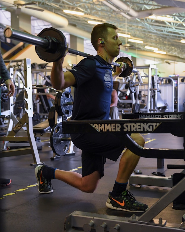 U.S. Air Force 2nd Lt. Alex Wagner, 633rd Contracting Squadron contract specialist, performs lunges at Joint Base Langley-Eustis, Virginia, Feb. 7, 2019.