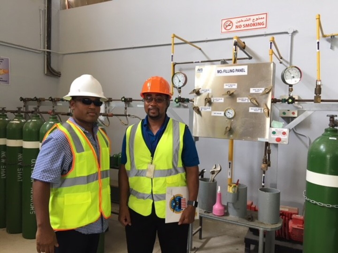 two men stand in safety vests