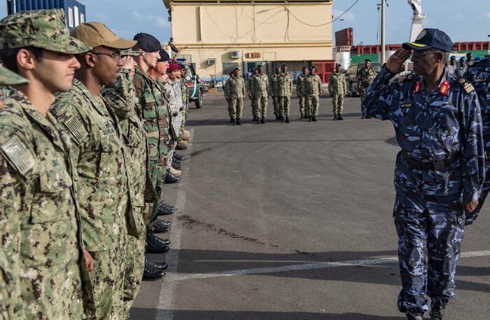 Sailors from the U.S., Indian, Comorian, Kenyan, Djiboutian and Somali navies along with U.S. Coast Guard sailors and Royal Netherlands Marines gather for the closing ceremony of exercise Cutlass Express 2019 in Djibouti, Feb. 6, 2019.