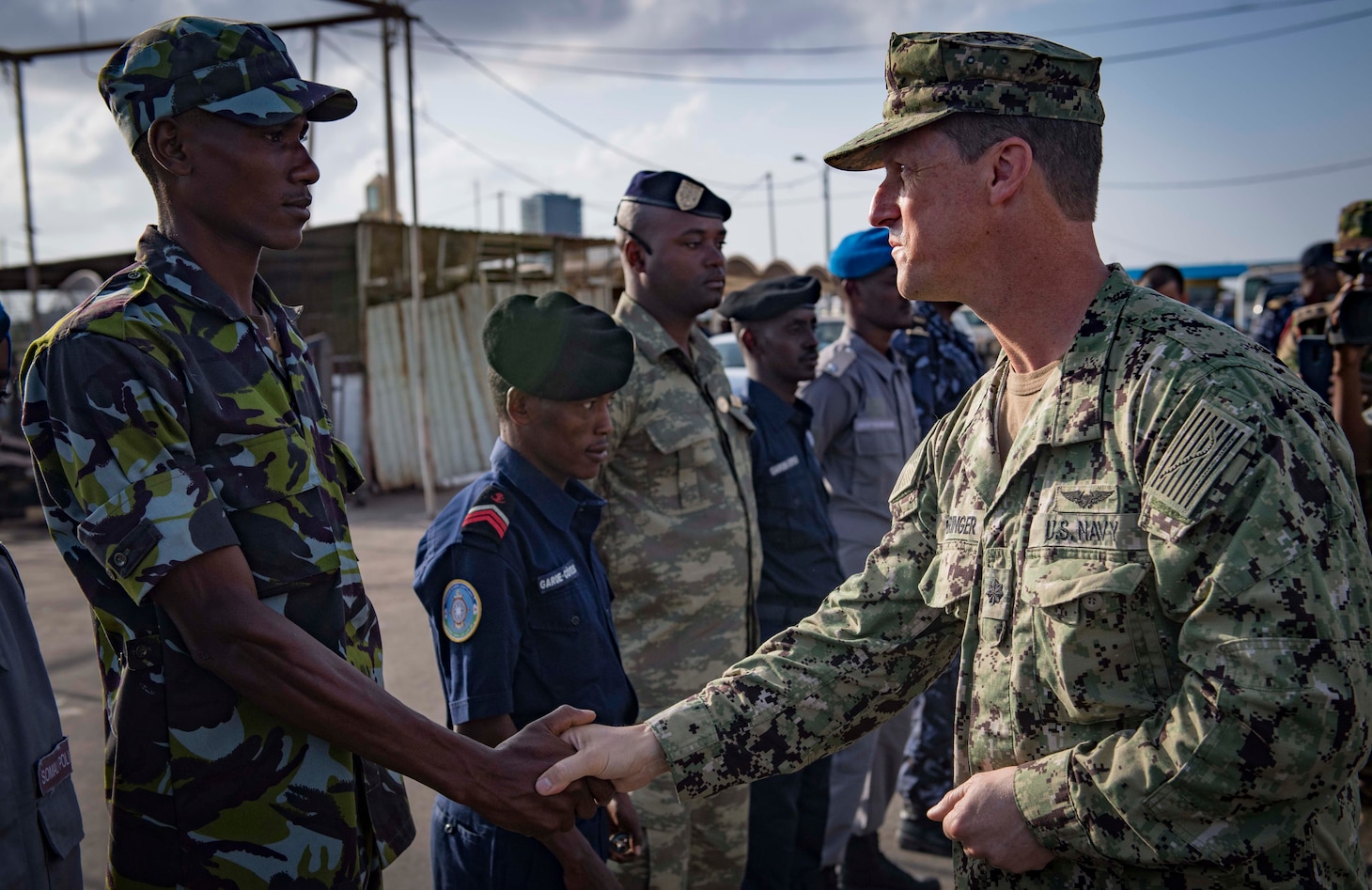 Sailors from the U.S., Indian, Comorian, Kenyan, Djiboutian and Somali navies along with U.S. Coast Guard sailors and Royal Netherlands Marines gather for the closing ceremony of exercise Cutlass Express 2019 in Djibouti, Feb. 6, 2019.