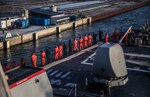 Sailors man the rails aboard the Arleigh Burke-class guided-missile destroyer USS Porter (DDG 78) while departing Copenhagen, Denmark, Feb. 4, 2019.