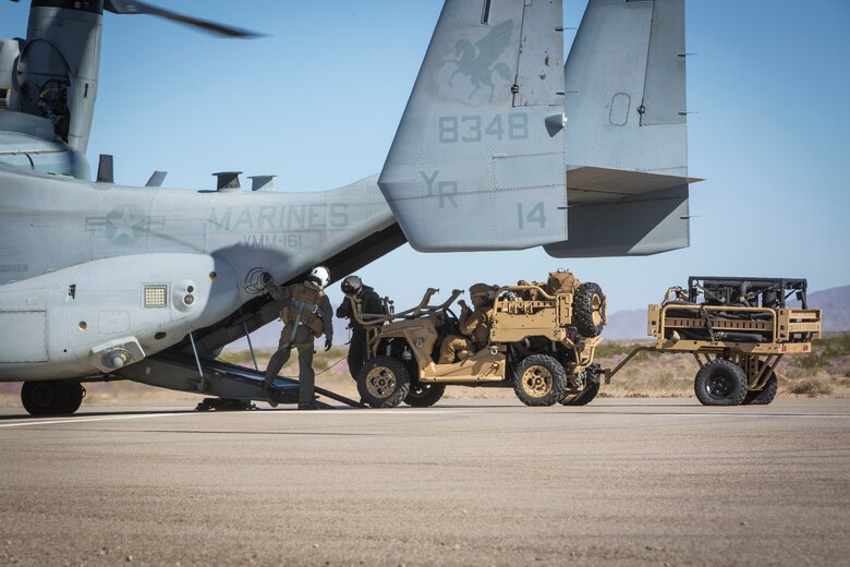 U.S. Marines assigned to Marine Wing Support Squadron 371 (MWSS-371) load a Polaris MRZR all-terrain vehicle onto a MV-22B Osprey at AUX II, one of the training ranges that belongs to Marine Corps Air Station Yuma, Ariz., Jan. 22, 2019.  The vehicle and bulk fuels specialists needed trasportation to Forward Armored Refueling Point -  LZ Star in order to set up light-weight camouflage screen systems (LCSS). The MV-22B is a tiltrotor aircraft with both vertical takoff and landing (VTOL), and short takeoff and landing capabilities (STOL) and is the primary assault support aircraft for the U.S. Marine Corps. Equipped with a turbo diesel engine and the ability to carry a payload of 1,000 lbs, the MRZR is a highly mobile vehicle that can handle supply transport missions, rapid personnel deployment, and more.