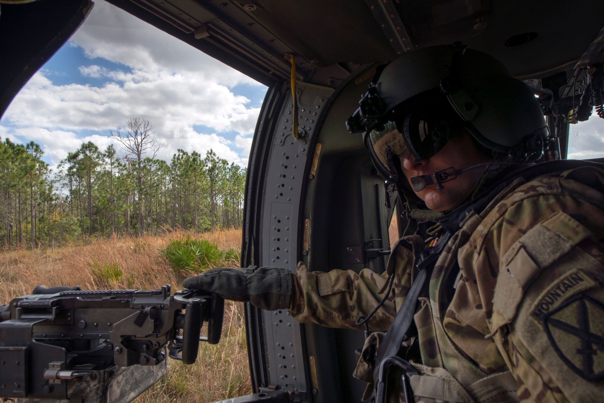 A U.S. Army 2-10 Assault Helicopter Battalion UH-60 Black Hawk gunner from Fort Drum, N.Y., provides aerial support during an Emerald Warrior combat search and rescue scenario, Avon Park, Florida, Jan. 22, 2019.