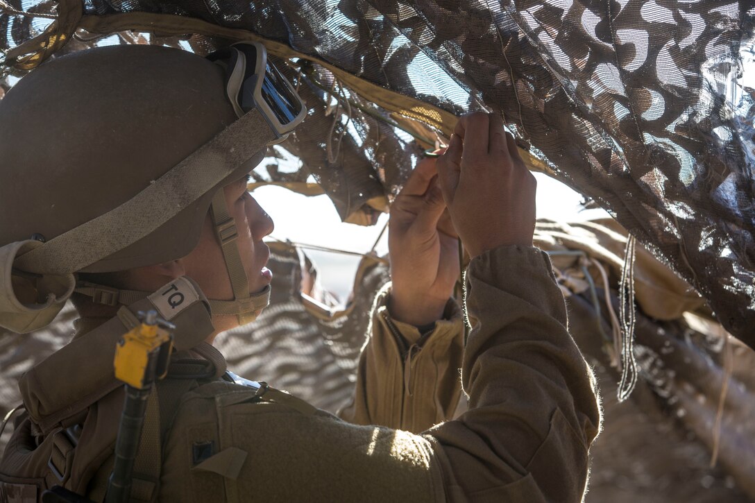 A U.S. Marine assigned to Marine Wing Support Squadron 371 (MWSS-371), helps set up a light-weight camouflage screen system (LCSS) at Forward Armored Refueling Point -  LZ Star, Jan. 22, 2019. During this portion of their training exercise, the bulk fuels specialists practiced working together to put together a camouflaged camp at FARP - LZ Star. MCAS Yuma is a prime location to conduct military training with its variety of different training range; both foreign military units and all branches of the U.S. military that visit the air station utilize the ranges throughout the year. (U.S. Marine Corps photo by Cpl. Isaac D. Martinez)