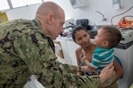 Cmdr. Edmund Milder examines a young patient during a visit to the Heraclio Emiliano Moda medical clinic in Axinim, Brazil, Feb. 6.