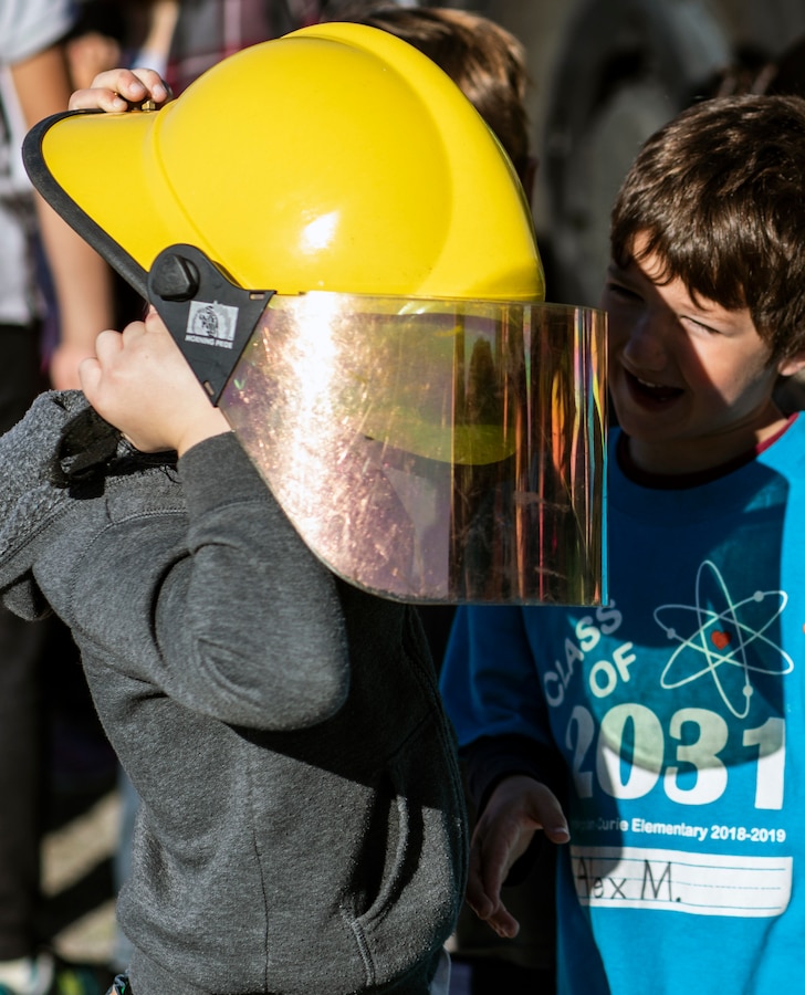 Curie Elementary School students try on Aircraft Rescue and Firefighting equipment during an ARFF demonstration at the Curie Elementary School, University City, Calif., Feb. 8. The Marines conducted this demonstration to teach students about the Aircraft Rescue and Firefighting military occupational specialty as well as foster cohesion with the surrounding community. (U.S. Marine Corps photo by Sgt. Jake McClung)
