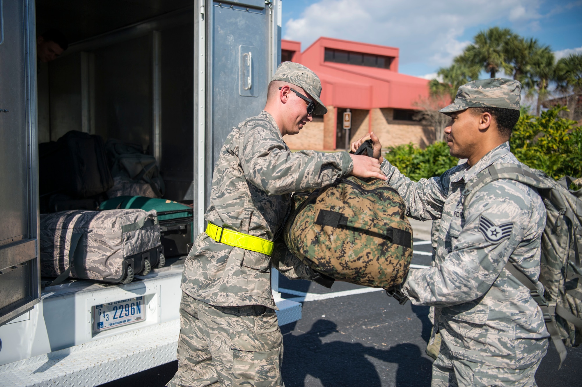 A 6th Logistics Readiness Squadron Airman assists a simulated deployer with their luggage during an operational readiness exercise at MacDill Air Force Base, Fla., Feb. 8, 2019. Total force Airmen from the 6th Air Mobility Wing and 927th Air Refueling Wing participated in the three-day exercise designed to emphasize the importance of combat skills effectiveness training and ensure Airmen are prepared for any potential contingencies.