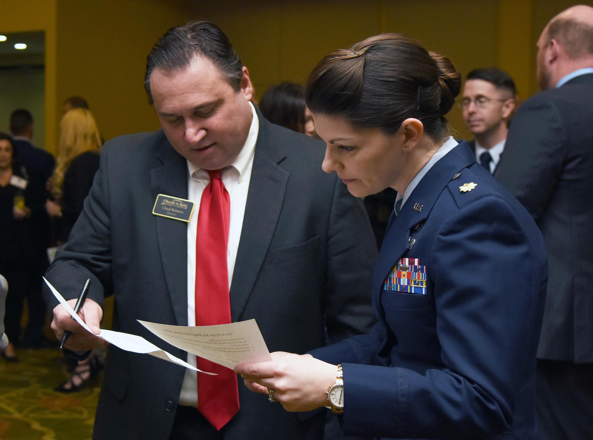 Chad Romero, D'Iberville/St. Martin Chamber of Commerce president, and U.S. Air Force Maj. Amber Ortiz, 81st Force Support Squadron commander, participate in an ice breaker game during the 2019 Honorary Commander Induction Ceremony inside the Bay Breeze Event Center at Keesler Air Force Base, Mississippi, Feb. 9, 2019. The event recognized the newest members of Keesler's honorary commander program, which is a partnership between military commanders and local civic and business leaders in order to enrich and strengthen the relationship between the base and the community. This was the first time leadership from the 2nd Air Force, 81st Training Wing and 403rd Wing combined to host a single joint induction ceremony. (U.S. Air Force photo by Kemberly Groue)
