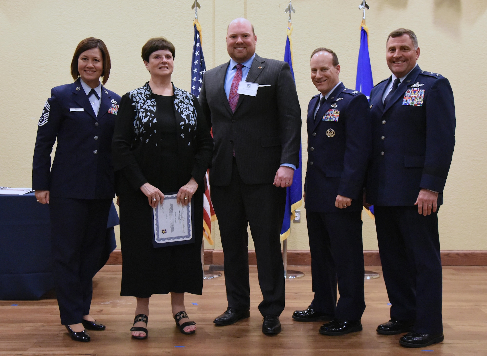 Leadership from 2nd Air Force pose for a group photo with the newly inducted honorary commanders during the 2019 Honorary Commander Induction Ceremony inside the Bay Breeze Event Center at Keesler Air Force Base, Mississippi, Feb. 9, 2019. The event recognized the newest members of Keesler's honorary commander program, which is a partnership between military commanders and local civic and business leaders in order to enrich and strengthen the relationship between the base and the community. This was the first time leadership from the 2nd Air Force, 81st Training Wing and 403rd Wing combined to host a single joint induction ceremony. (U.S. Air Force photo by Kemberly Groue)