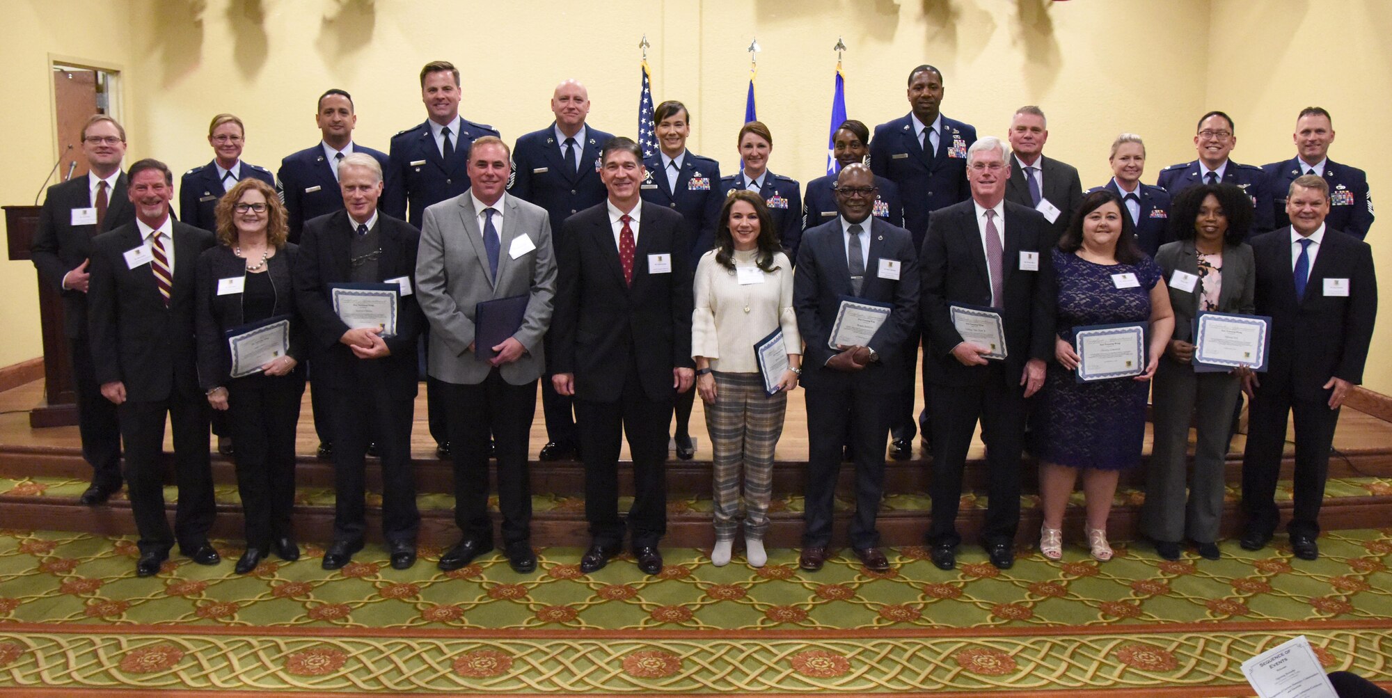 Leadership from the 81st Training Wing pose for a group photo with the newly inducted honorary commanders during the 2019 Honorary Commander Induction Ceremony inside the Bay Breeze Event Center at Keesler Air Force Base, Mississippi, Feb. 9, 2019. The event recognized the newest members of Keesler's honorary commander program, which is a partnership between military commanders and local civic and business leaders in order to enrich and strengthen the relationship between the base and the community. This was the first time leadership from the 2nd Air Force, 81st Training Wing and 403rd Wing combined to host a single joint induction ceremony. (U.S. Air Force photo by Kemberly Groue)