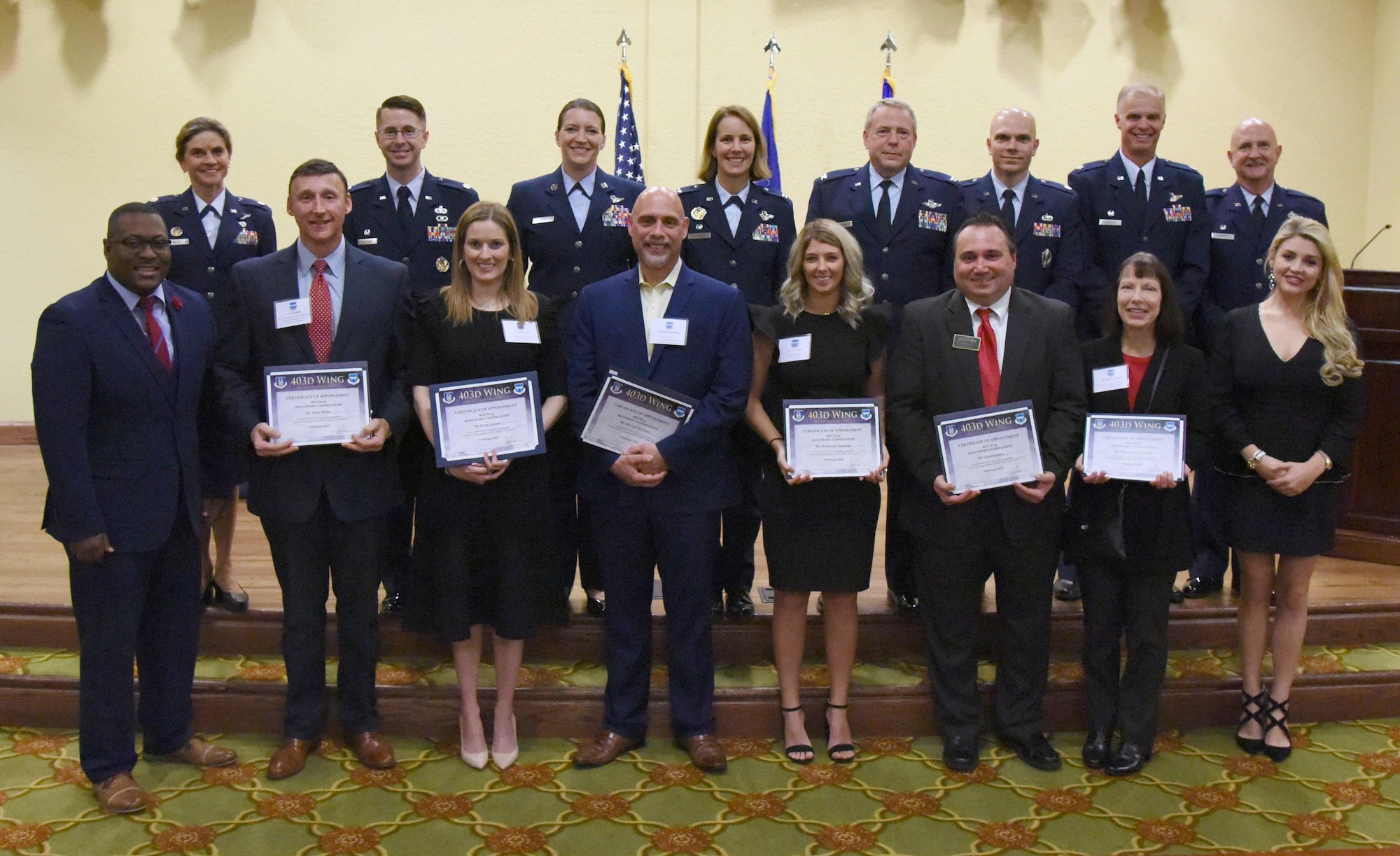 Leadership from the 403rd Wing pose for a group photo with the newly inducted honorary commanders during the 2019 Honorary Commander Induction Ceremony inside the Bay Breeze Event Center at Keesler Air Force Base, Mississippi, Feb. 9, 2019. The event recognized the newest members of Keesler's honorary commander program, which is a partnership between military commanders and local civic and business leaders in order to enrich and strengthen the relationship between the base and the community. This was the first time leadership from the 2nd Air Force, 81st Training Wing and 403rd Wing combined to host a single joint induction ceremony. (U.S. Air Force photo by Kemberly Groue)