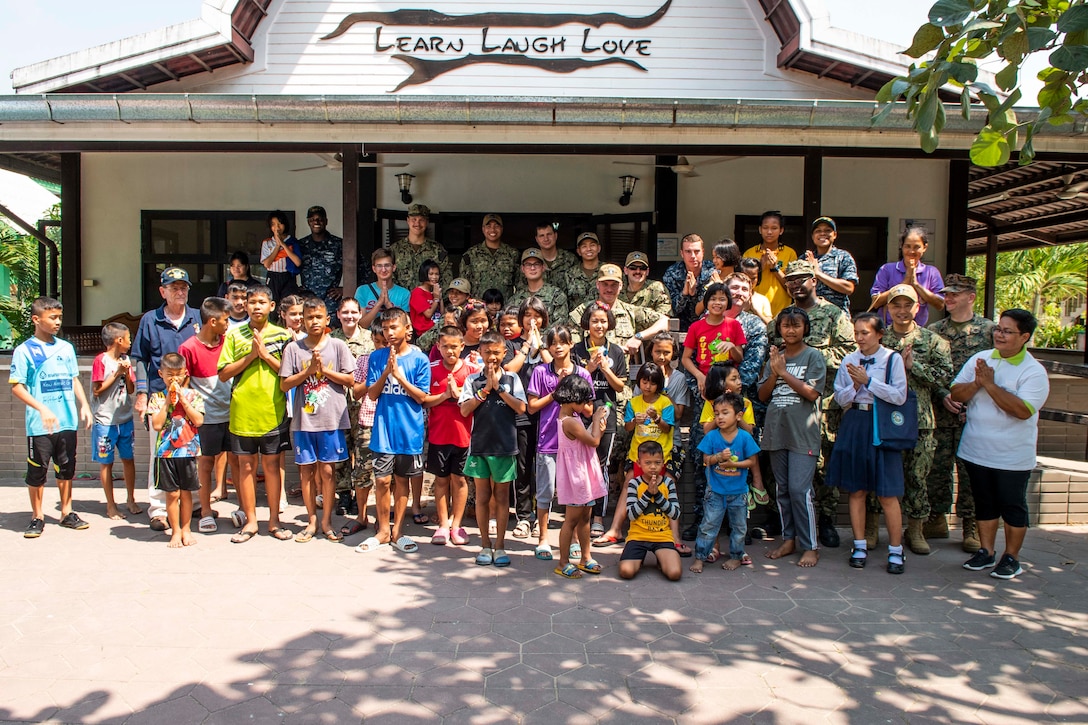 190209-N-DX072-1387 CHONBURI, Thailand (Feb. 9, 2019) – Sailors and Marines assigned to the amphibious transport dock ship USS Green Bay (LPD 20) pose for a group photos during a community service project at the Child Protection and Development Center in Chonburi, Thailand. Green Bay, part of the Wasp Amphibious Ready Group, with embarked 31st Marine Expeditionary Unit (MEU), is in Thailand to participate in Exercise Cobra Gold 2019. Cobra Gold is a multinational exercise co-sponsored by Thailand and the United States that is designed to advance regional security and effective response to crisis contingencies through a robust multinational force to address common goals and security commitments in the Indo-Pacific region.