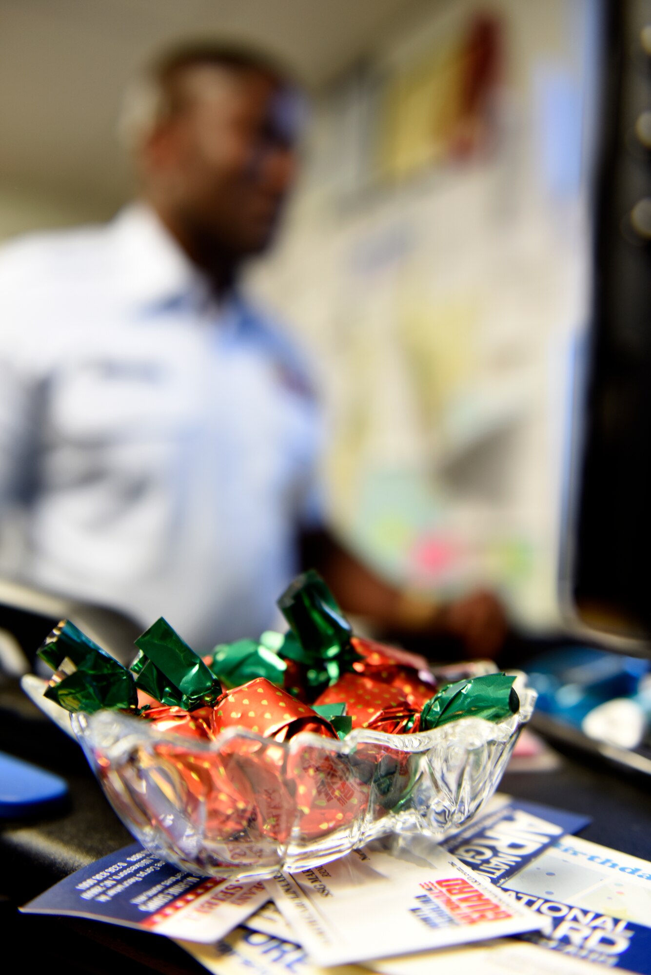 A bowl full of candy is nestled on the desk of U.S. Air Force Tech. Sgt. Francis Strother, recruiter for the 145th Airlift Wing,  at the North Carolina Air National Guard (NCANG) Base, Charlotte Douglas International Airport, Jan. 13, 2019. Strother was enticed to join the military when he ran across an American soldier at an Embassy in Liberia that handed him some candy.