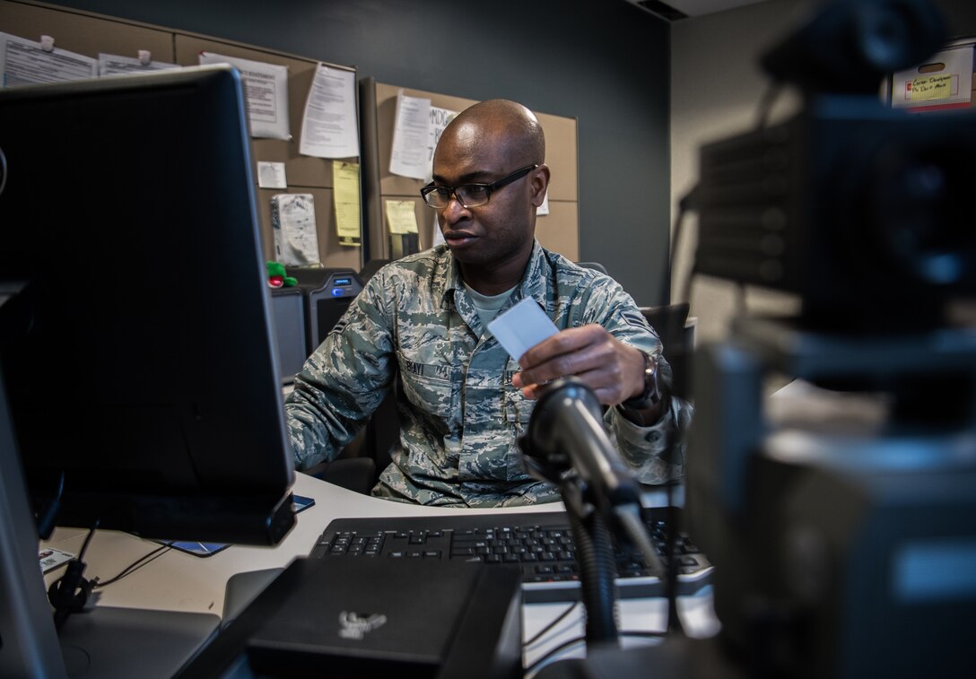 Airman First Class Nestor Biayi, personalist with the 932nd Force Support Squadron, prepares a blank identification card to be created Feb. 8, 2019, Scott Air Force Base, Illinois. Biayi joined the Air Force Reserve to both serve his country, but utilize the great educational benefits while serving. (U.S. Air Force photo by Christopher Parr)