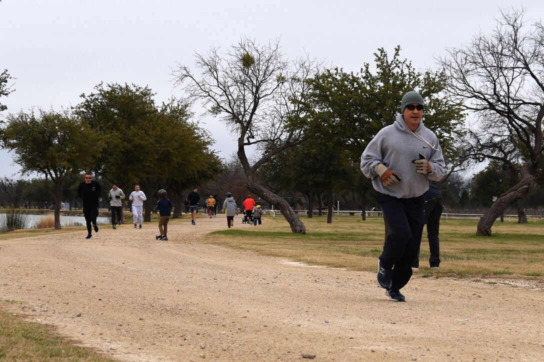 U.S. Air Force Col. Ricky Mills, 17th Training Wing commander, joins in the 5K to kick off the annual Polar Bear Run and Swim at the Goodfellow Recreation Camp on Lake Nasworthy Feb. 9, 2019. After the run, most participants suited up to plunge in to the 42 degree lake water. (U.S. Air Force photo by Senior Airman Seraiah Hines/Released)