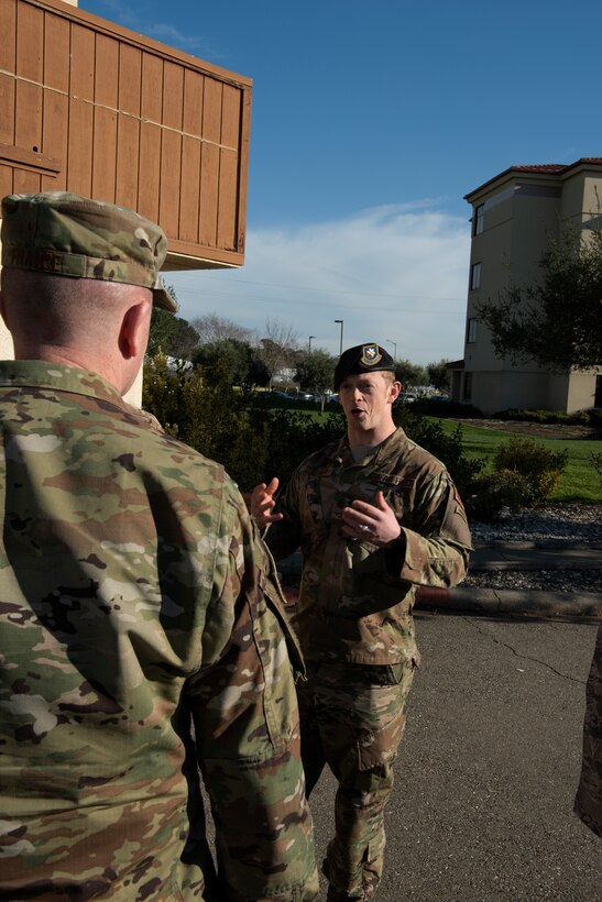 Maj. Matthew Stillman, 60th Security Forces Squadron operations officer, speaks with Chief Master Sgt. Jason France, U.S. Transportation Command Senior Enlisted Leader, Feb. 7, 2019 during a visit at Travis Air Force Base, Calif. During his visit, France observed security forces use of force training, toured the installation and met with senior leaders. (U.S. Air Force photo by Tech. Sgt. James Hodgman)
