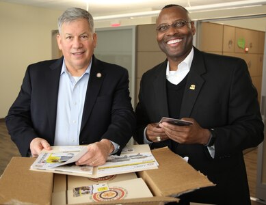 Retired Army Lt. Gen. Raymond V. Mason, director of Army Emergency Relief (left), and retired Army Command Sgt. Maj. Charles E. Durr Jr., AER chief of assistance, review AER educational materials at U.S. Army Installation Management Command headquarters at Joint Base San Antonio-Fort Sam Houston Jan. 23.