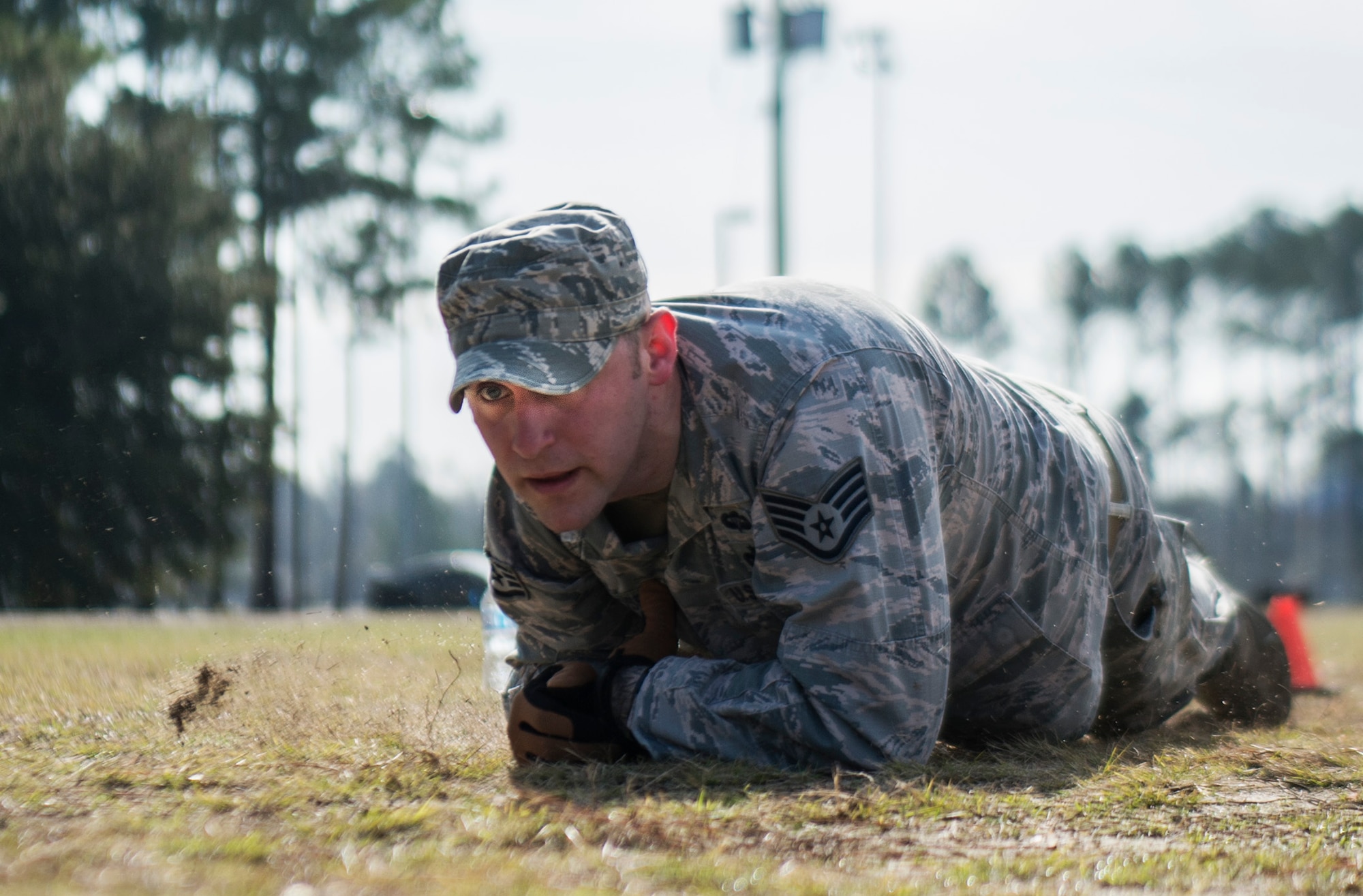 U.S. Air Force Staff Sgt. Christopher Gross, 20th Security Forces installation patrolman, low crawls during physical training at Shaw Air Force Base, S.C., Feb. 6, 2019.