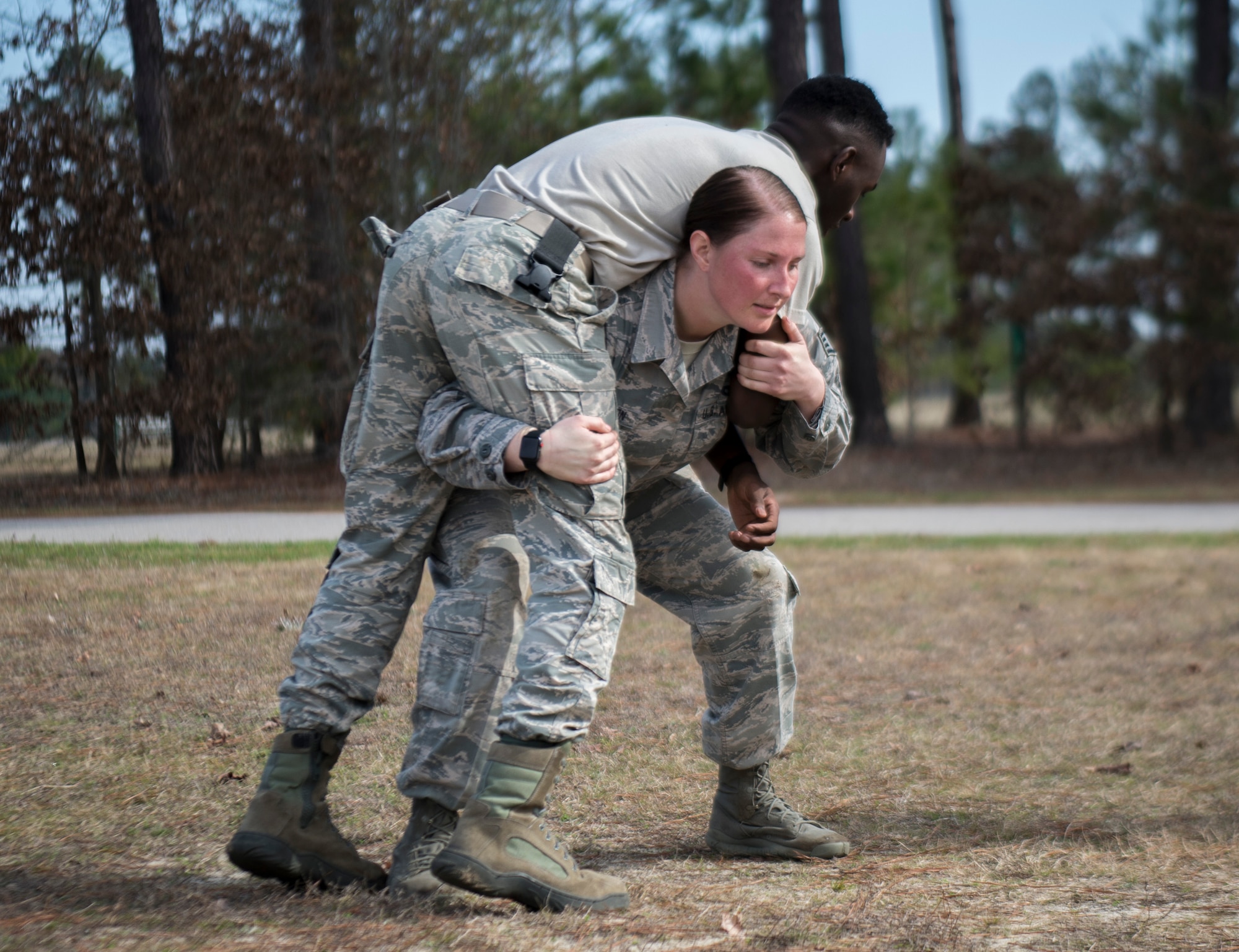 U.S. Air Force Staff Sgt. Heather Seifert-Olson, 20th Security Forces Squadron installation patrolman, fireman carries a wingman during physical training at Shaw Air Force Base, S.C., Feb. 6, 2019.