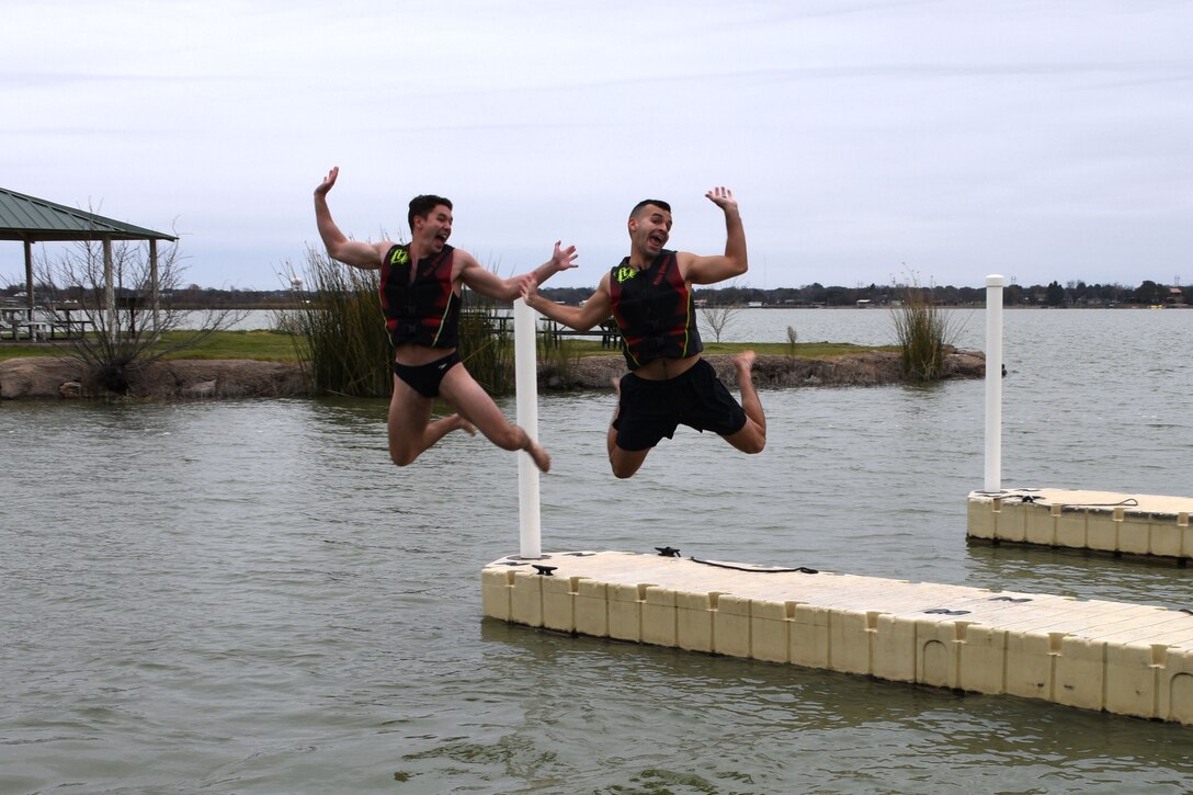 U.S. Air Force 2nd Lt. Christian Gilbert and 2nd Lt. Christian Nazario, 315th Training Squadron students, strike a pose before hitting the 42 degree water of Lake Nasworthy at the annual Polar Bear Run and Swim at the Goodfellow Recreation Camp Feb. 9, 2019. After plunging into the lake participants could enjoy S’mores and food by a fire. (U.S. Air Force photo by Senior Airman Seraiah Hines/Released)