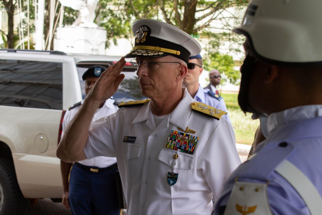 The commander of U.S. Southern Command, Navy Adm. Craig Faller, salutes upon arrival to Brazil's Air Force headquarters in Brasília.