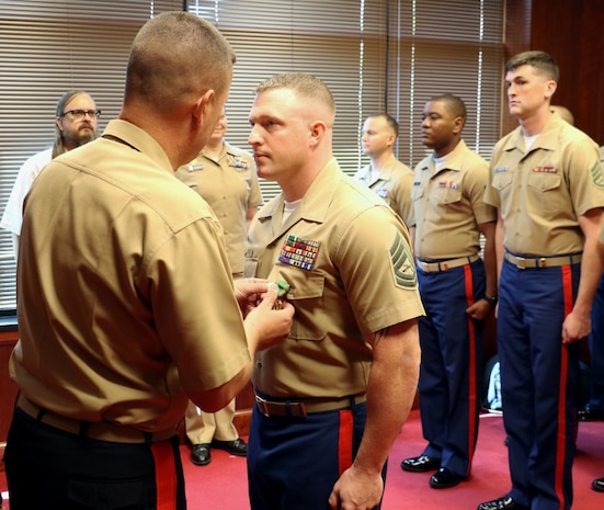 MILWAUKEE, Wisc. --- Gunnery Sgt. Pete Vargo, the staff noncommissioned officer-in-charge of Recruiting Substation Green Bay, was presented the Navy and Marine Corps Achievement Medal Thursday, August 2nd by Major Gen. James Bierman during a visit to Marine Corps Recruiting Station Milwaukee. Vargo was awarded the medal for his swift response and assistance at a vehicle crash on I-41 in Washington County that left seven injured and took the life of an 18-year-old.