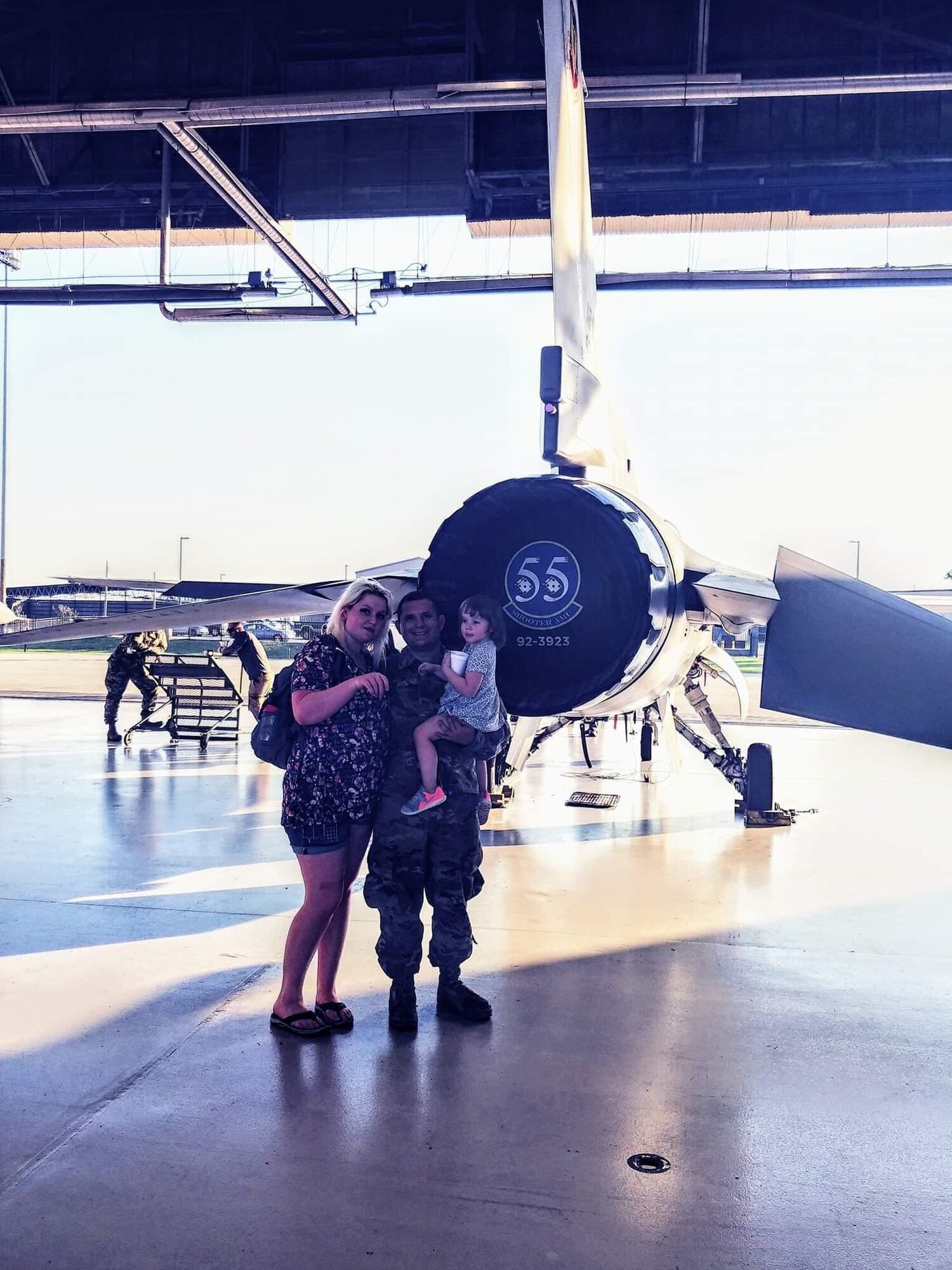 Staci Farland stands with her husband, Staff Sgt. Nick Farland, Fuel System Repair element electrical environmental systems apprentice, and their daughter in a hangar at Shaw Air Force Base, S.C., Nov. 11, 2018.